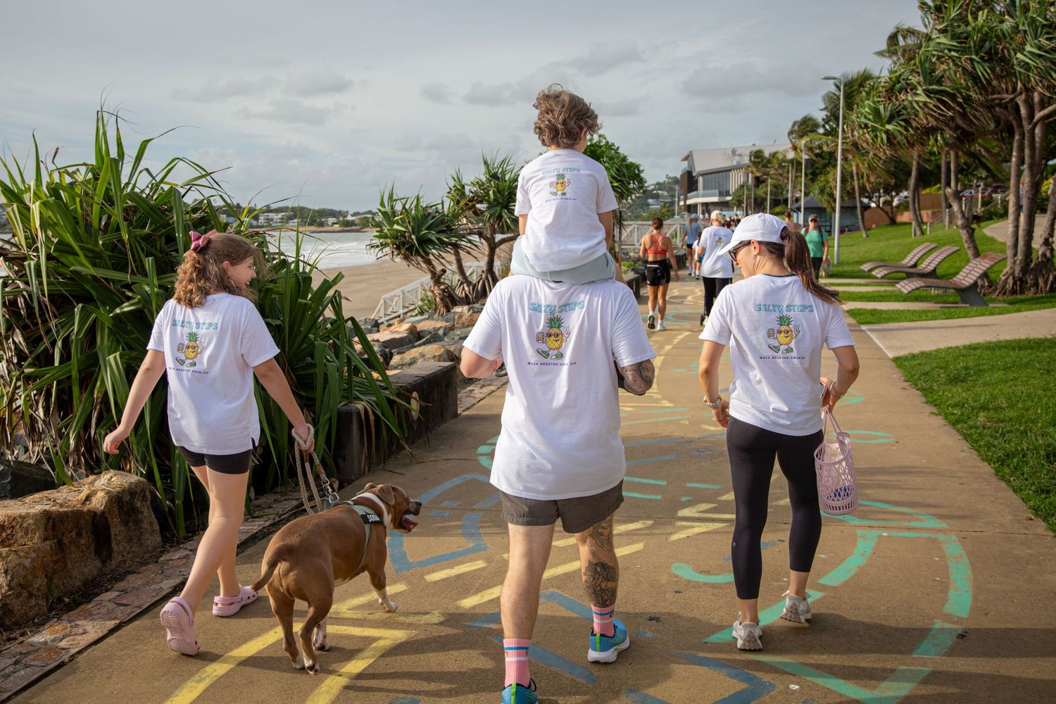 Families and kids walking along coastal footpath during Salty Steps event in Yeppoon
