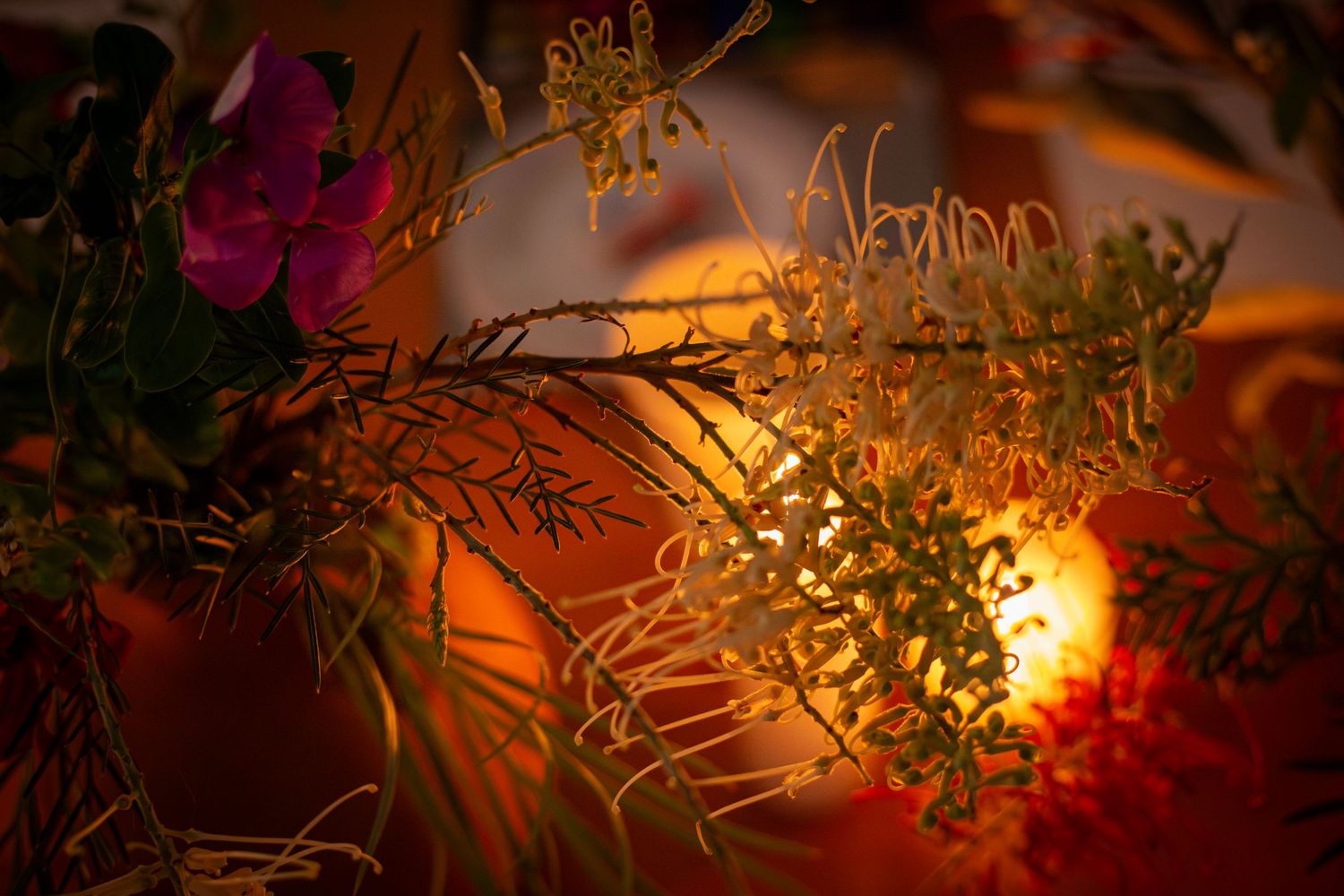 Colourful flower arrangement with moody lighting and candles during a branding shoot in Rockhampton