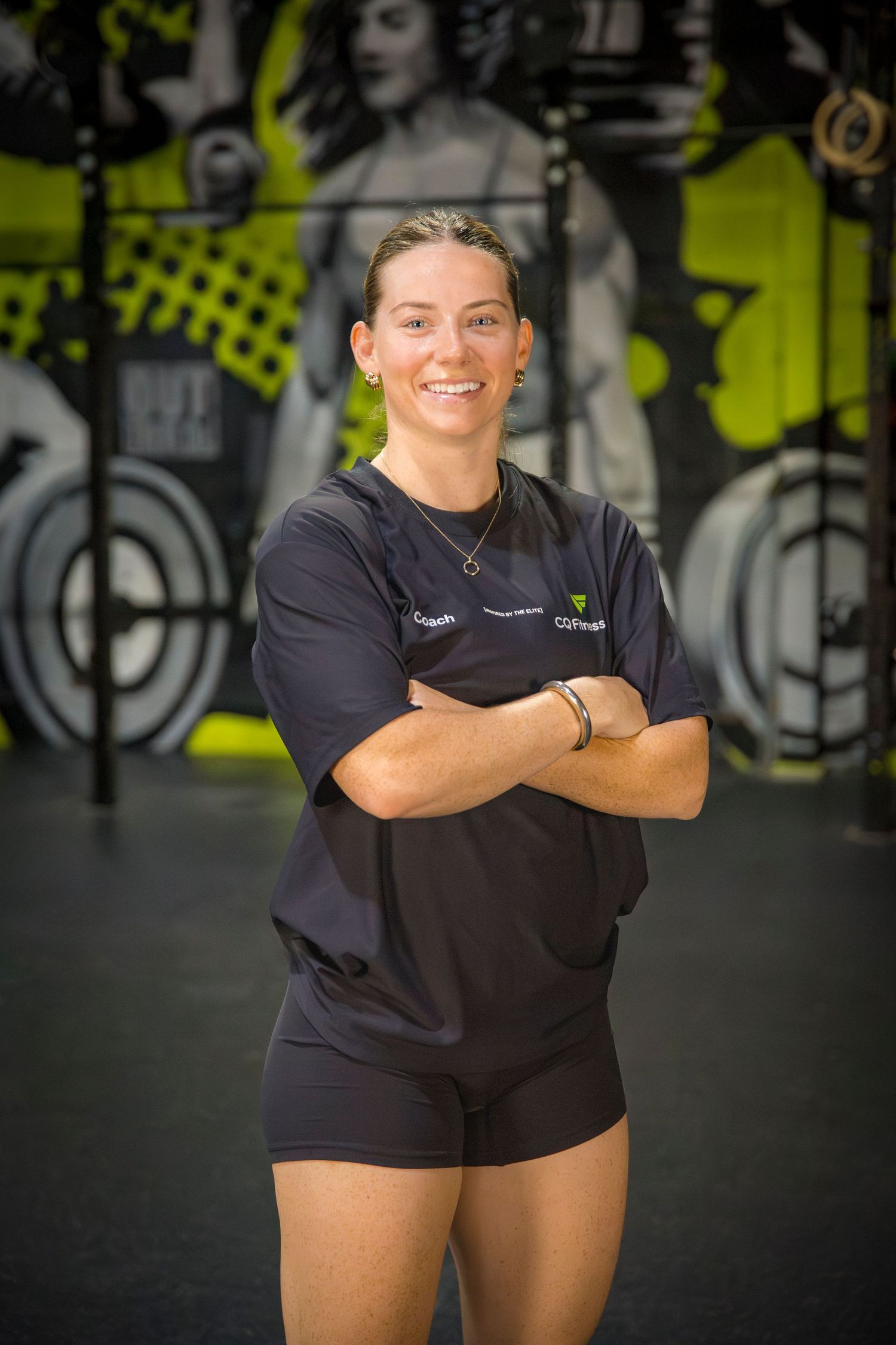 Gym coach headshots in front of gym mural at Rockhampton CrossFit location