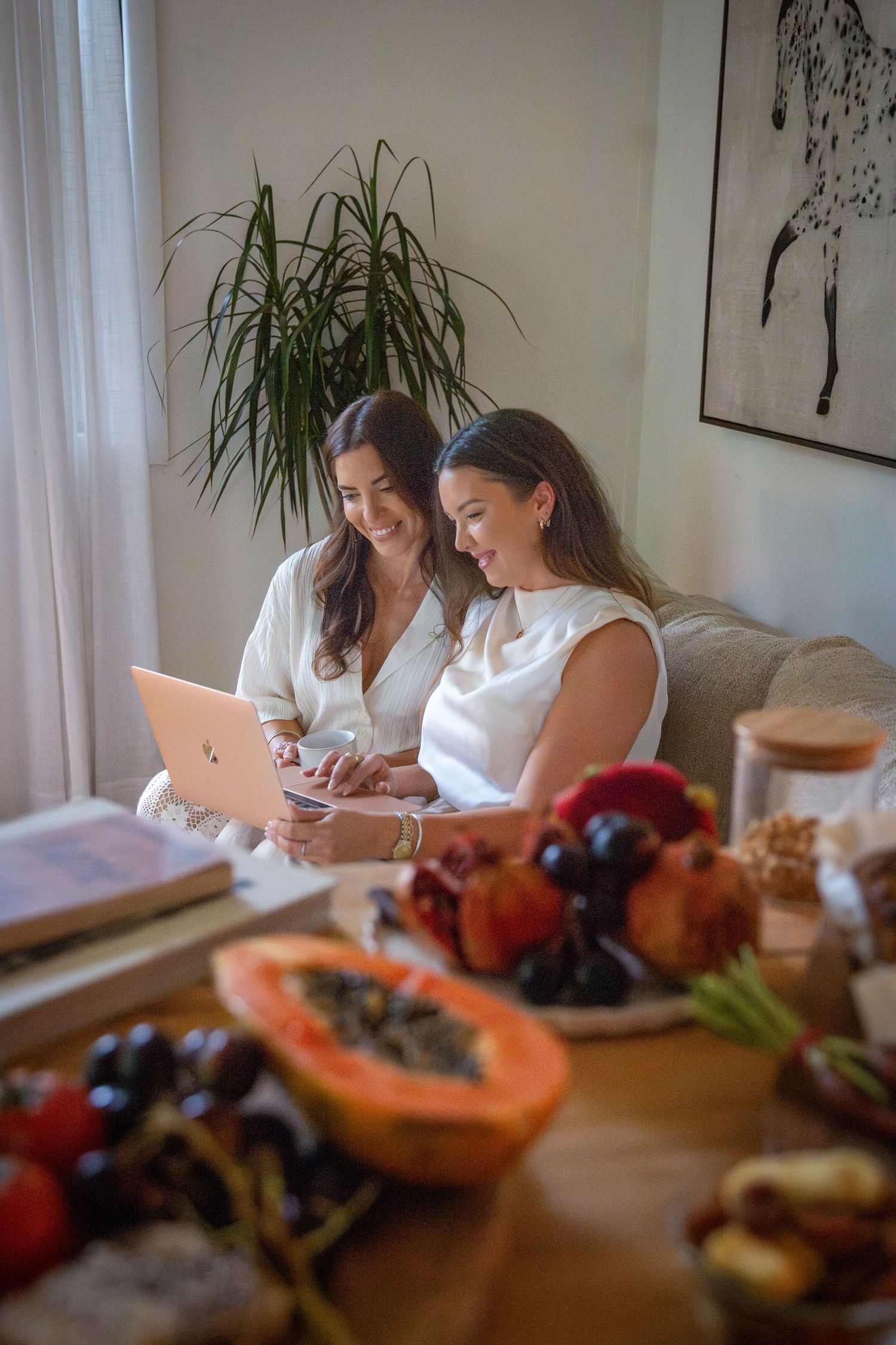 two women working on laptop at creative branding photography session Rockhampton
