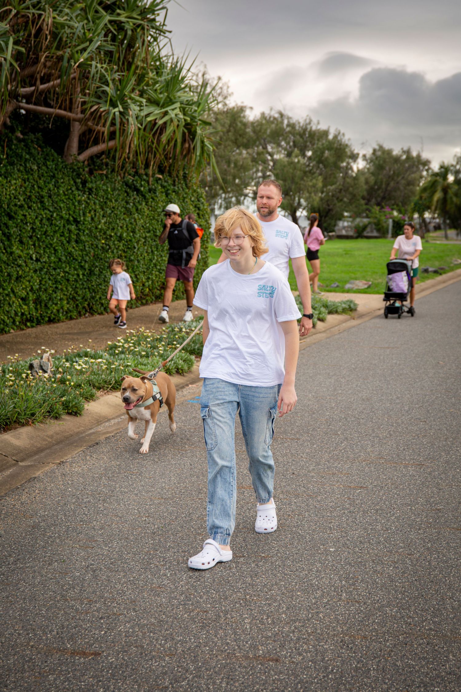 Group walking along scenic coastal path in Yeppoon