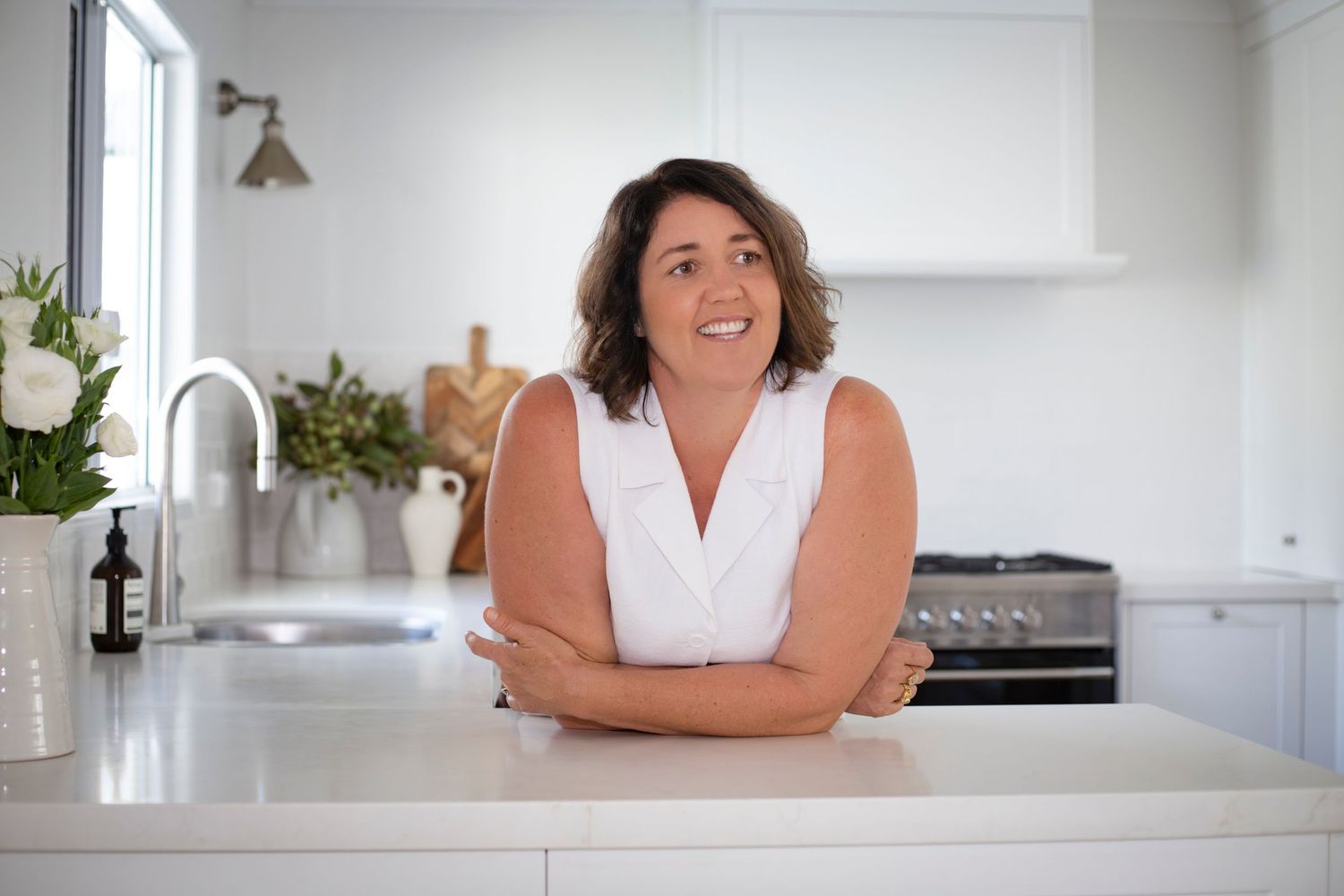 Businesswoman working at her kitchen bench during a relaxed personal branding shoot in Rockhampton