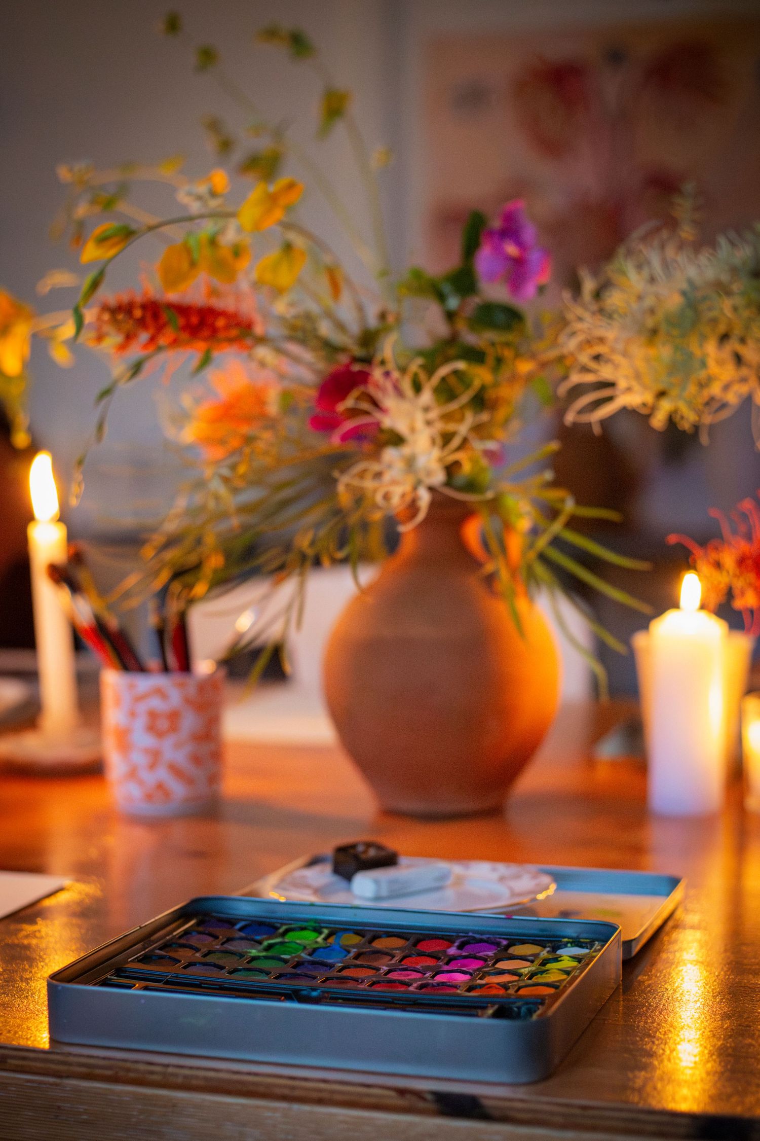 Vibrant table centrepieces with warm lighting – event styling photography Rockhampton