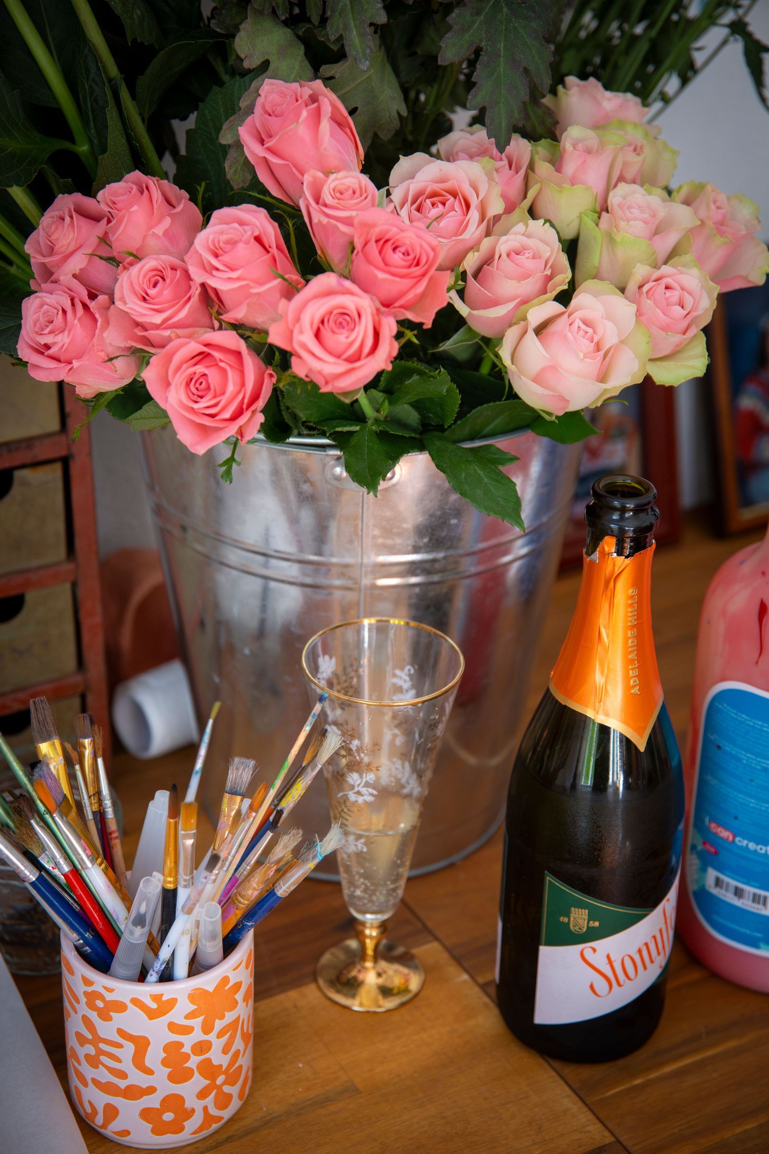 Bouquet of pink flowers and wine bottles styled on a table during a Rockhampton Christmas party