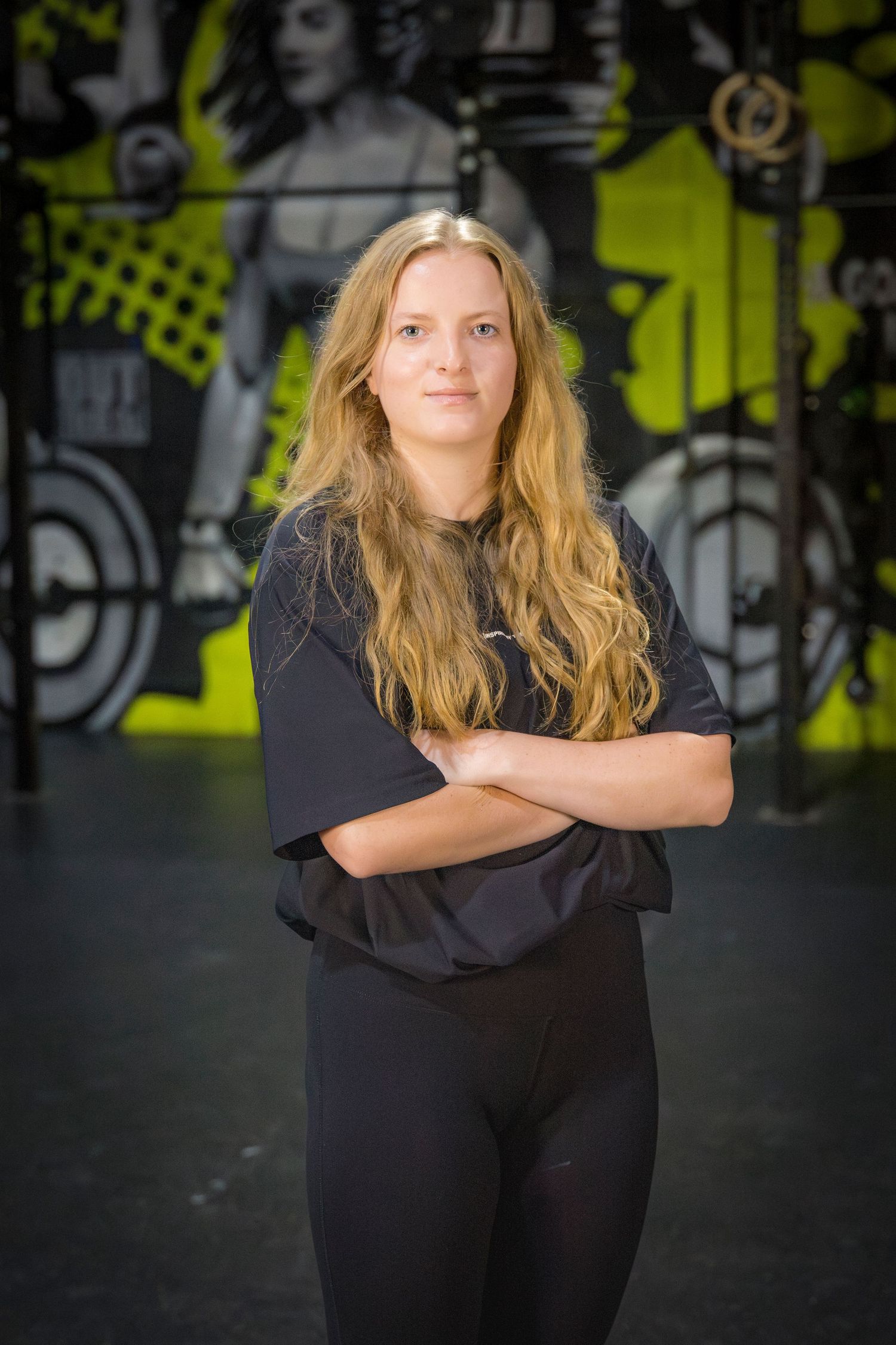 Gym staff headshots in front of gym mural at Rockhampton CrossFit location