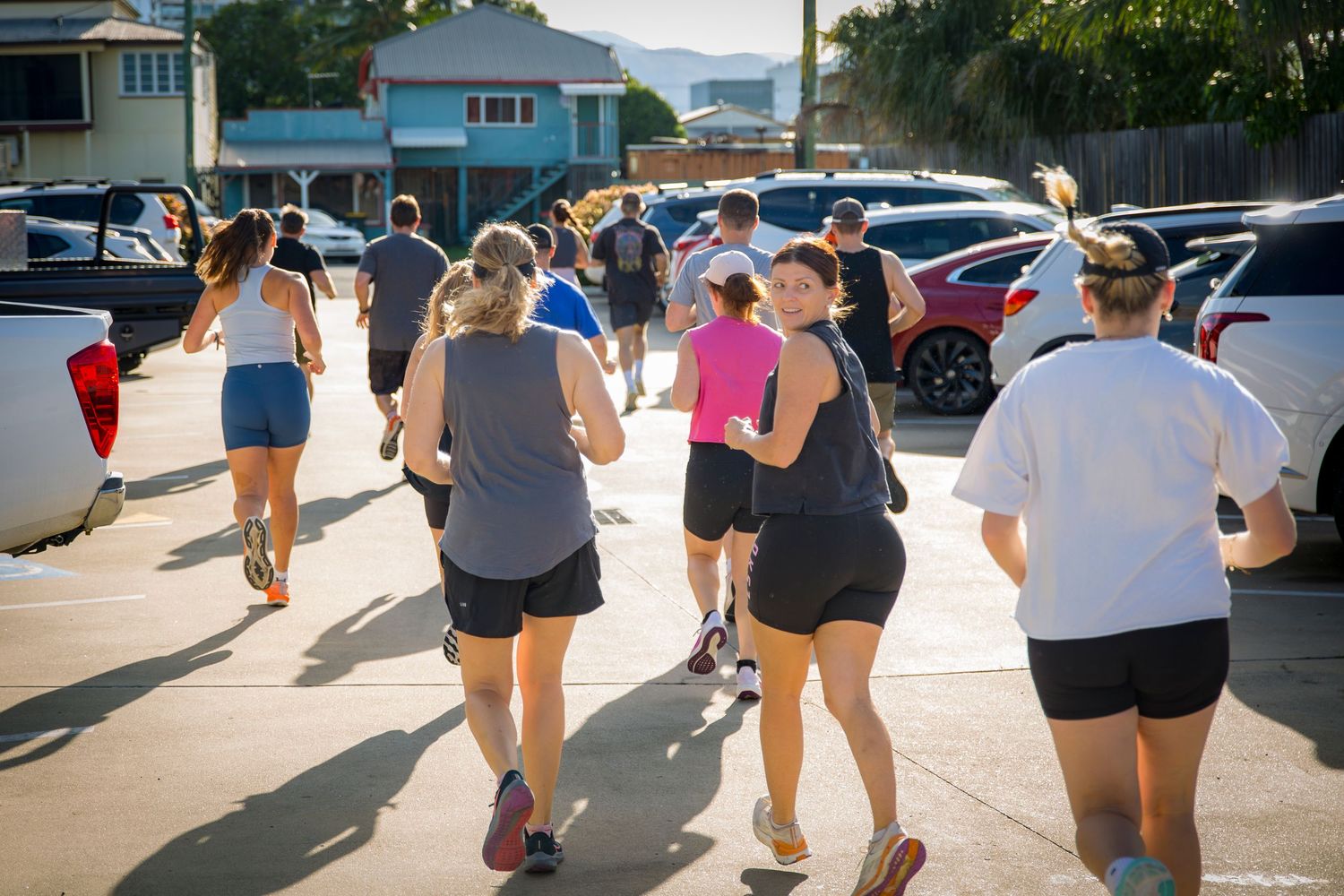 Gym members on outdoor run at CQ Fitness Co during high-energy workout