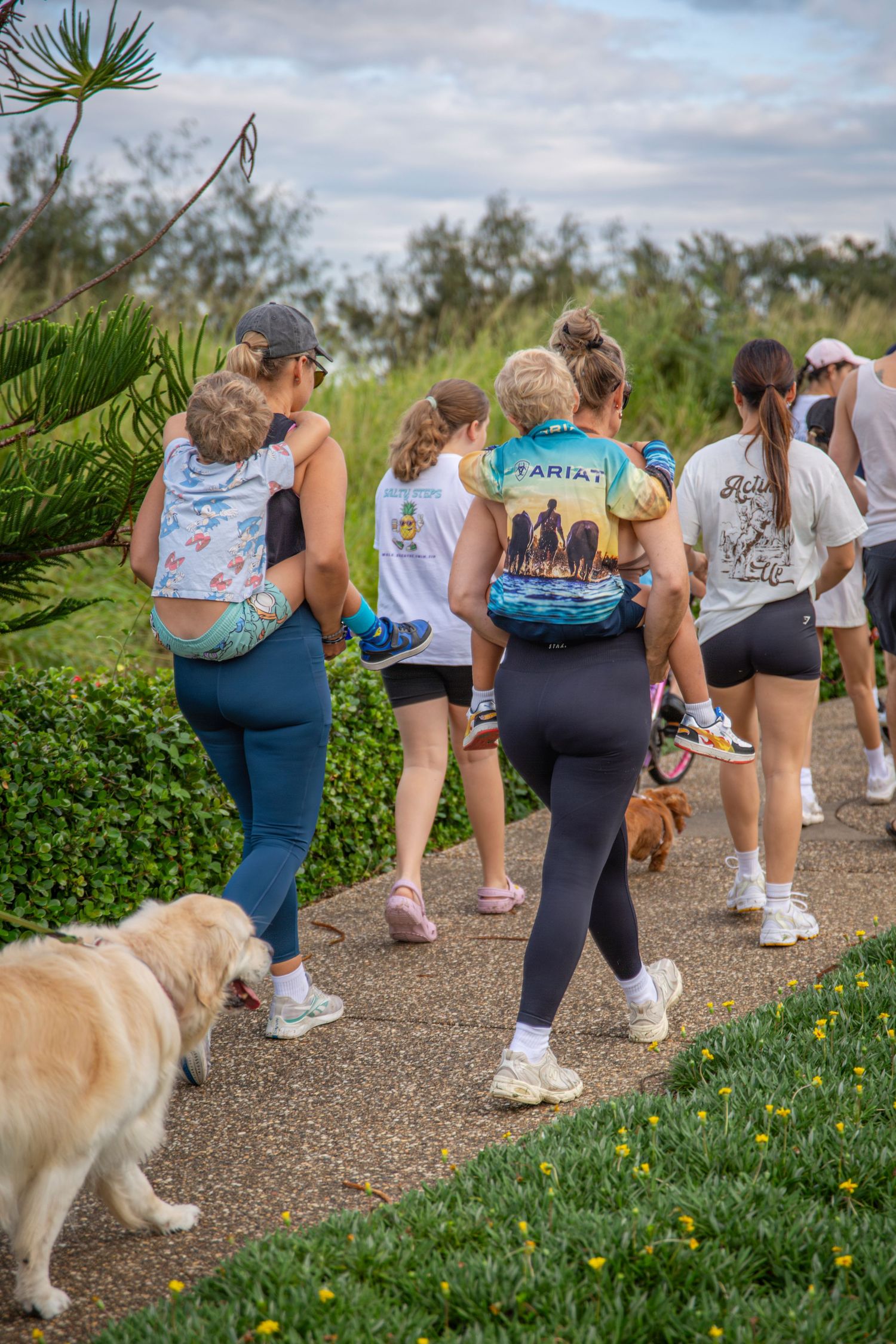 Group walking along scenic coastal path in yeppoon at community event