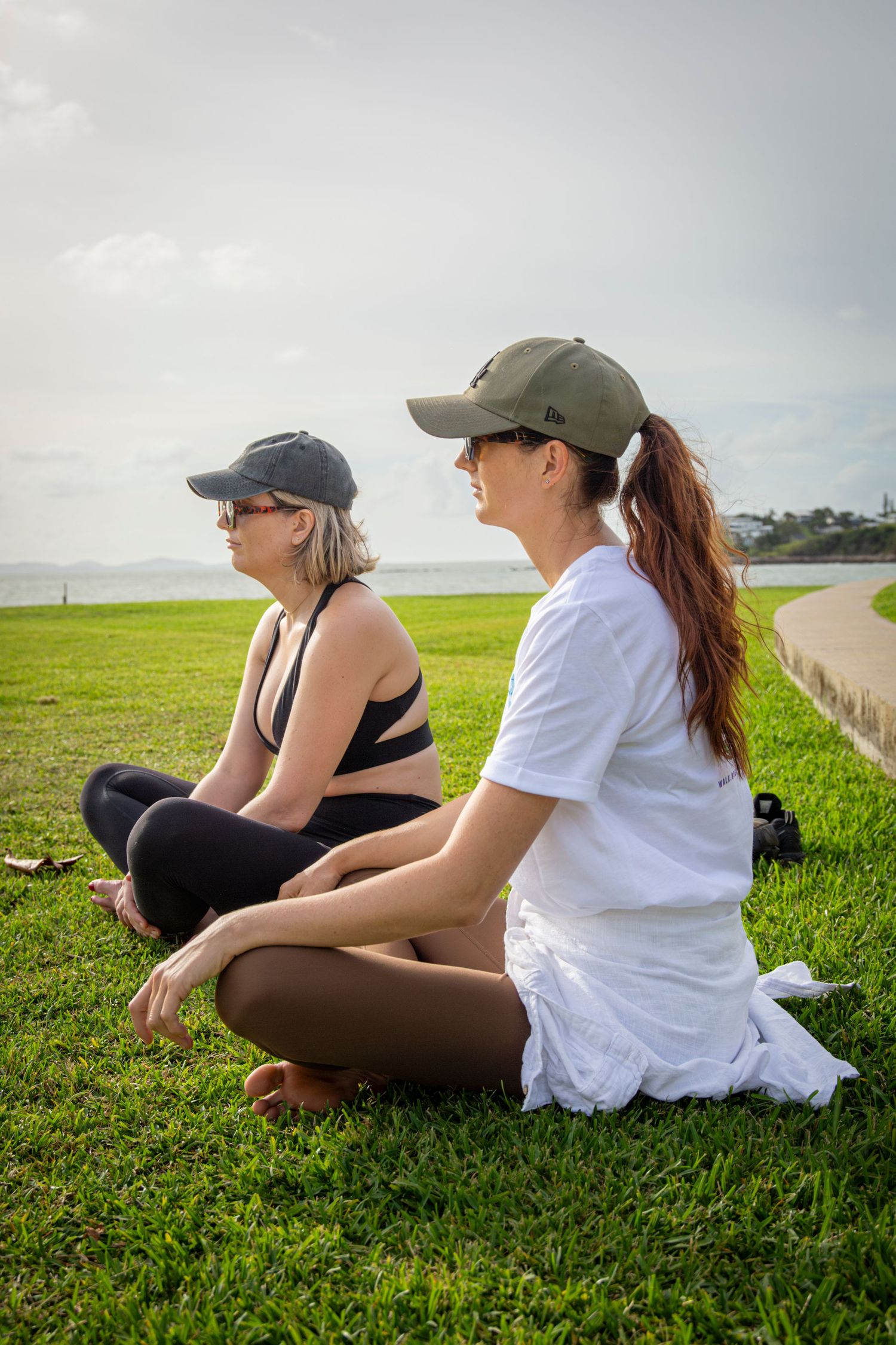 Women sitting in a circle by the ocean during a Salty Steps community event