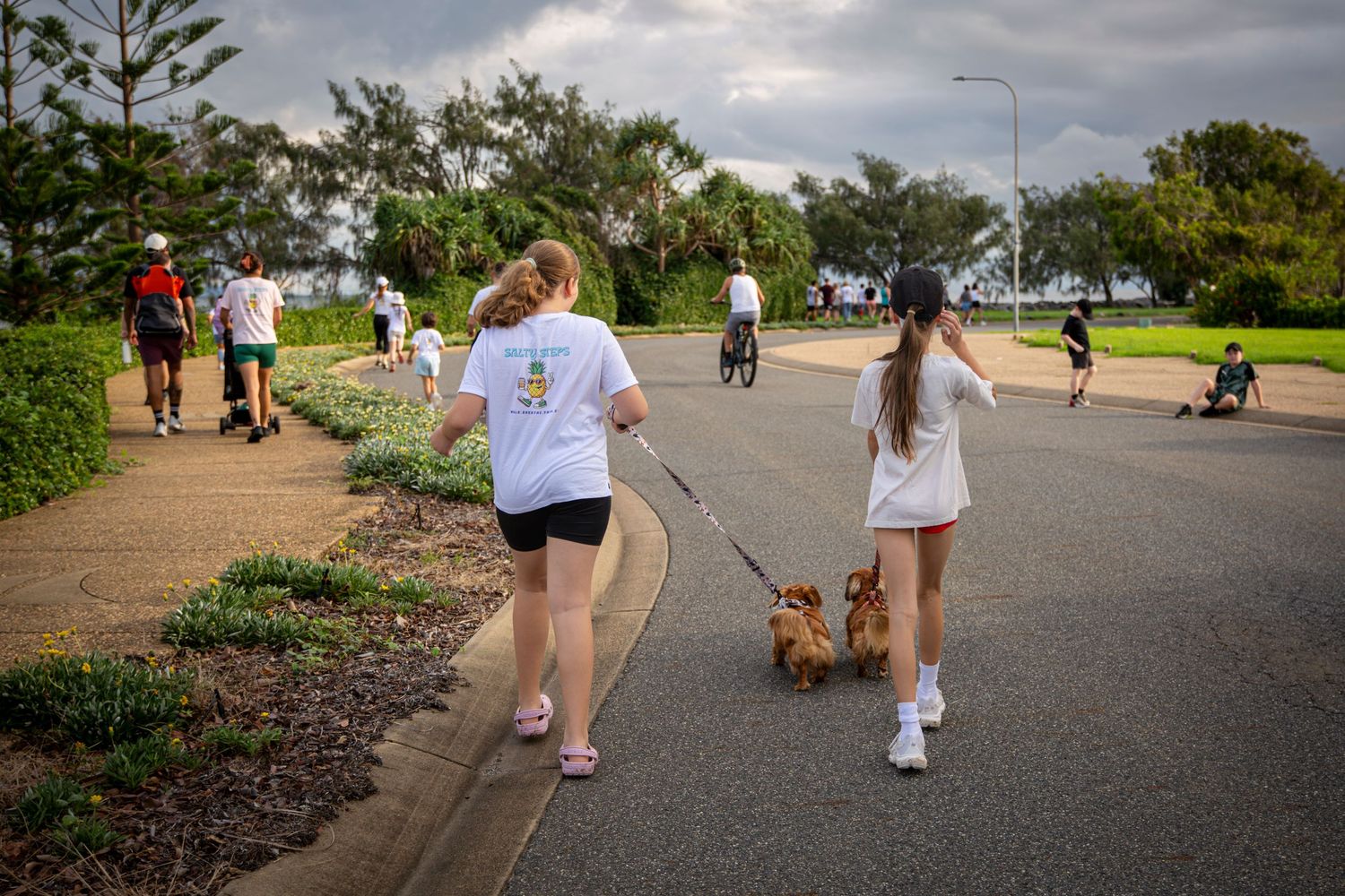 Group walking along scenic coastal path in Yeppoon