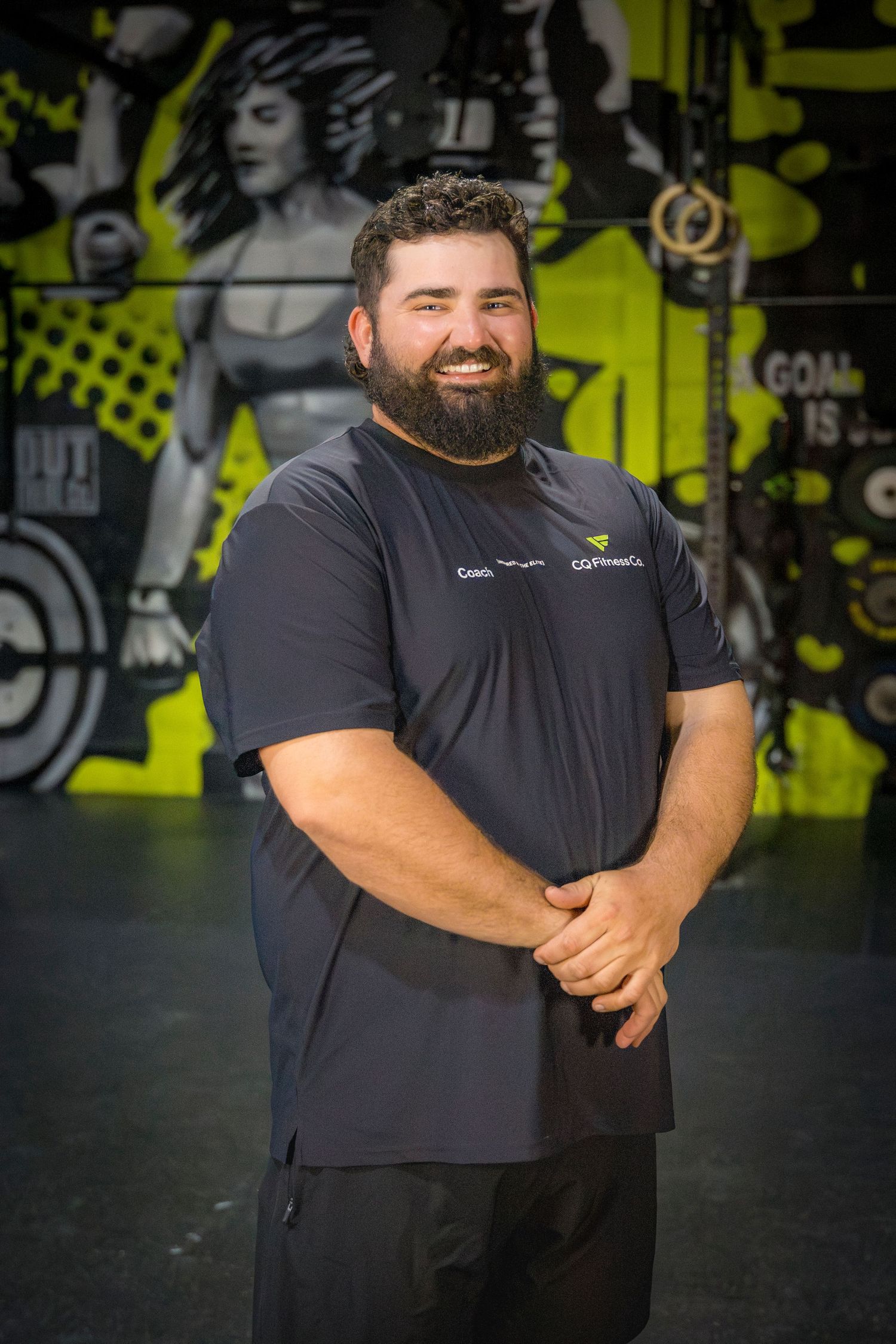Gym coach headshots in front of gym mural at Rockhampton CrossFit location