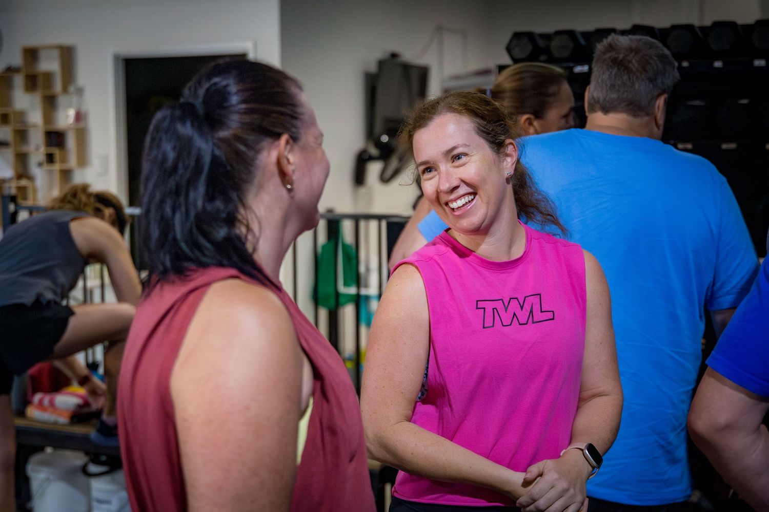 Friendly moment between gym members during a branding shoot at a Rockhampton CrossFit gym, highlighting community and connection