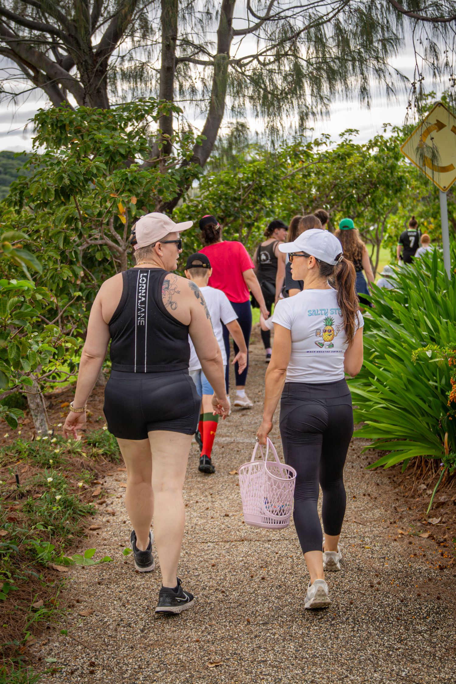 Group walking along scenic coastal path in Yeppoon
