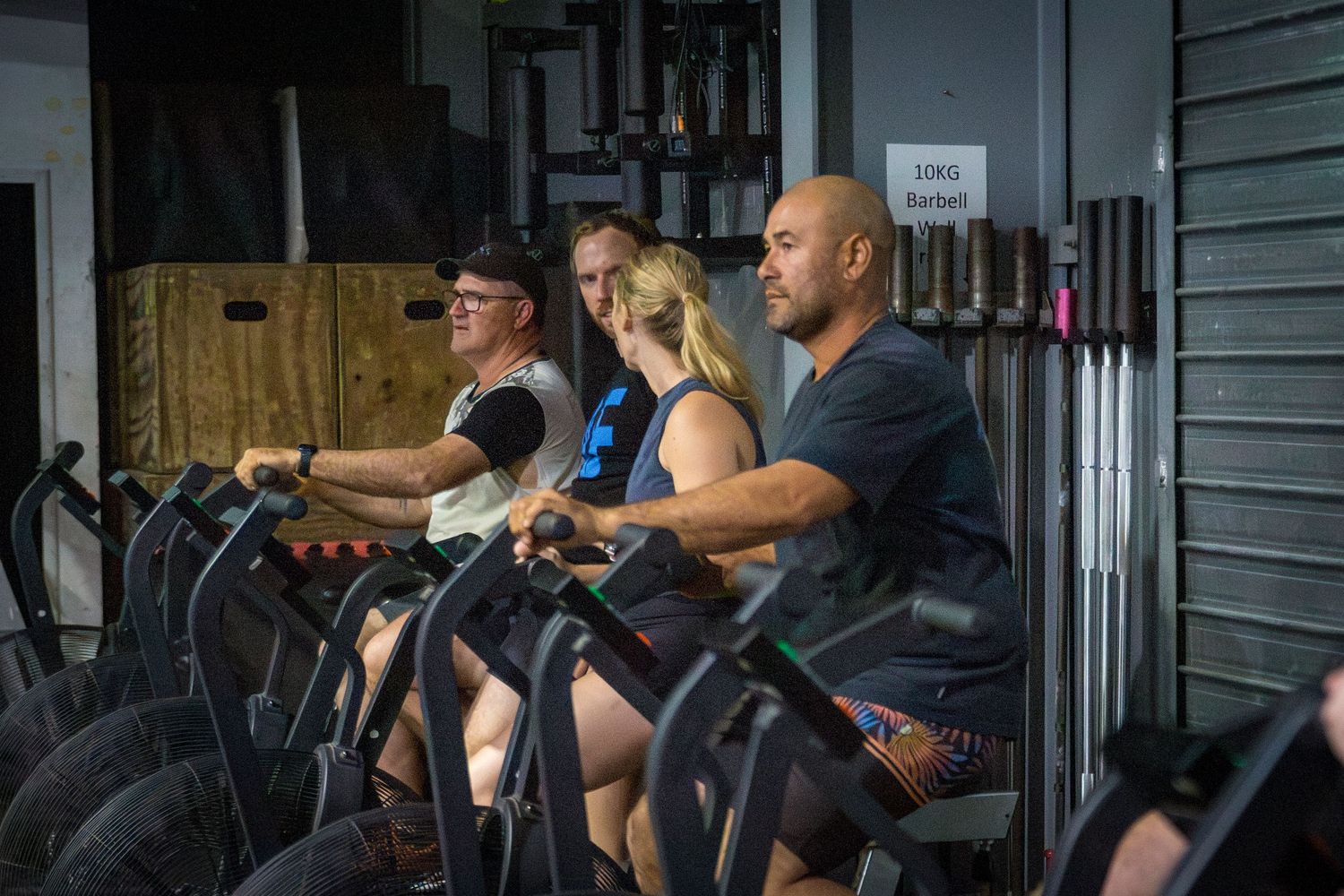 Gym members on bike at CQ Fitness Co during high-energy workout