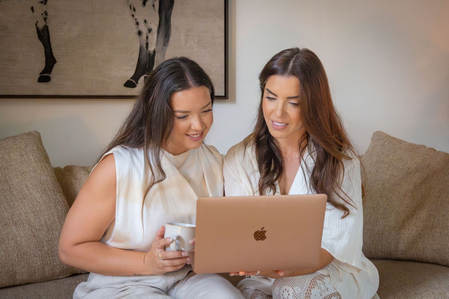 Two women working on laptop in modern, minimal studio rockhampton branding photography