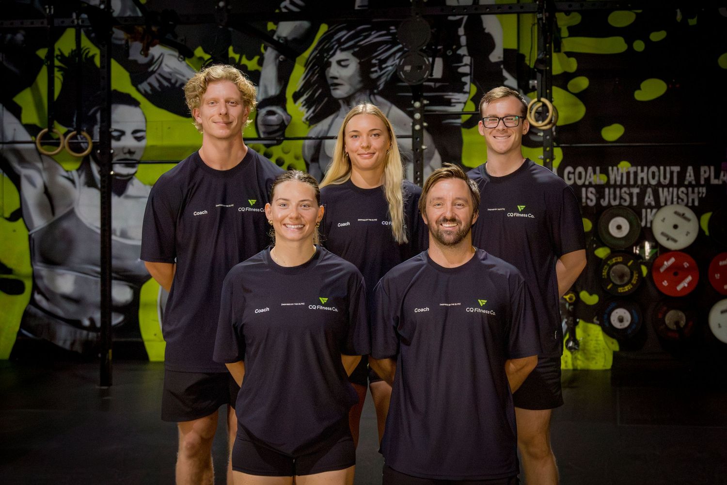 Team photo of gym staff in matching uniforms at Rockhampton fitness brand shoot