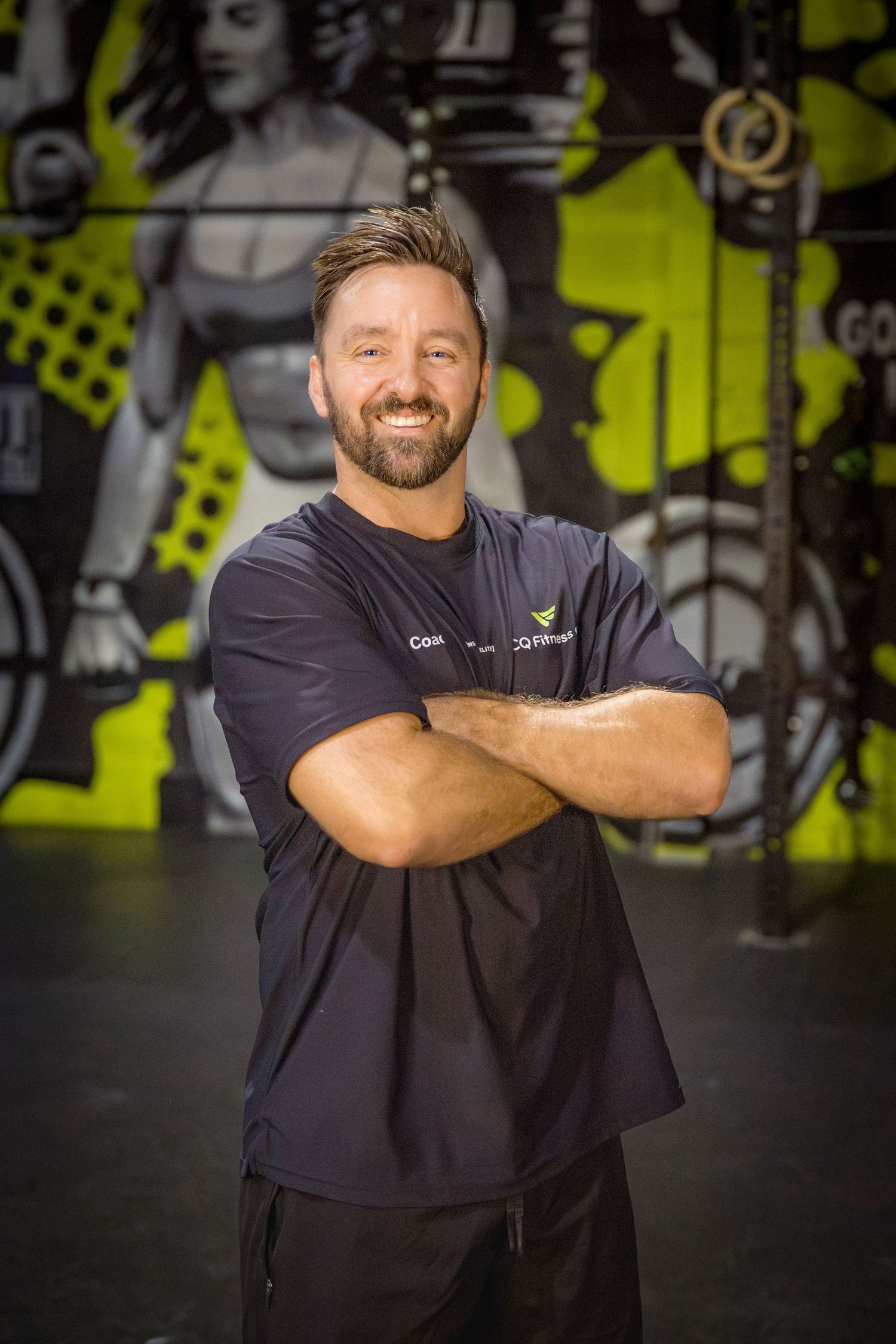 Gym coach headshots in front of gym mural at Rockhampton CrossFit location