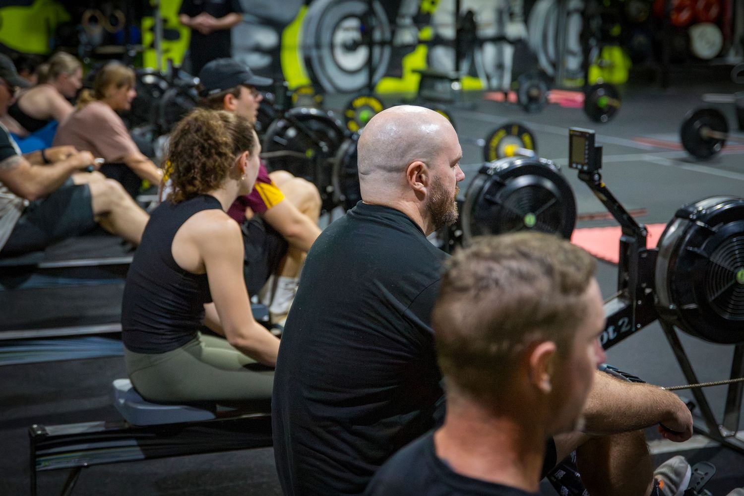 Gym member on rower at CQ Fitness Co during high-energy workout