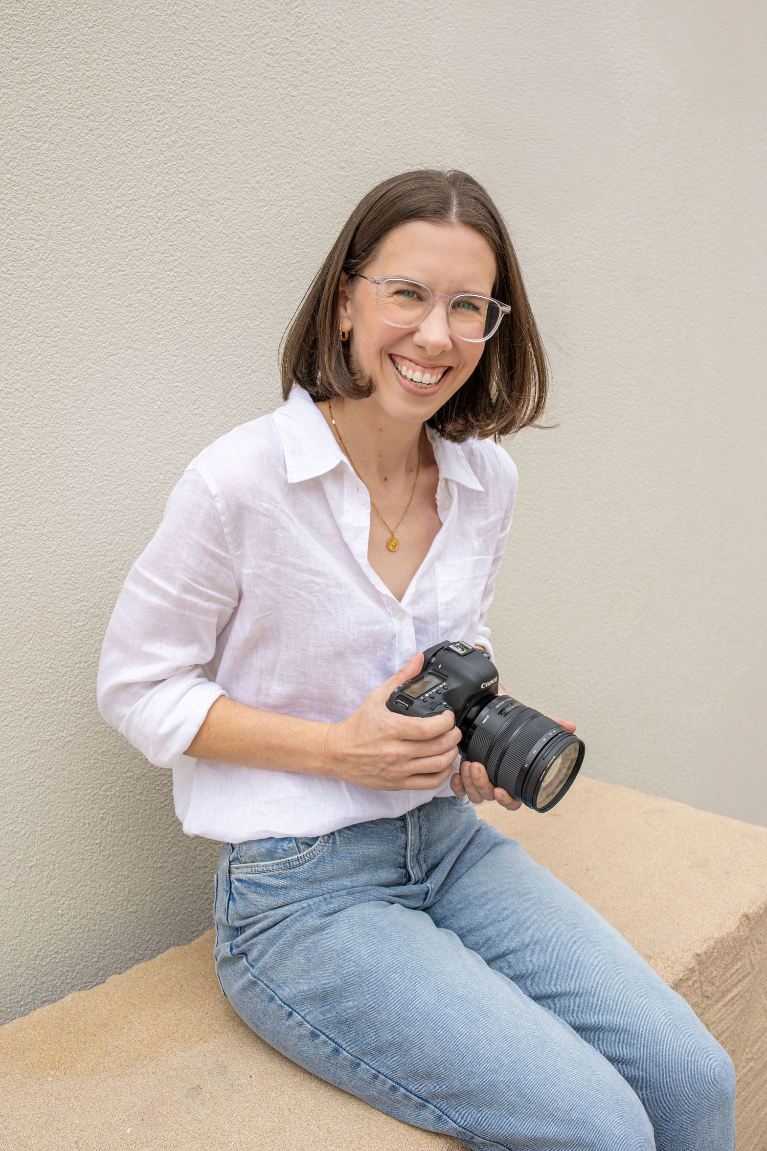 Female photographer posing with camera in Rockhampton photography studio