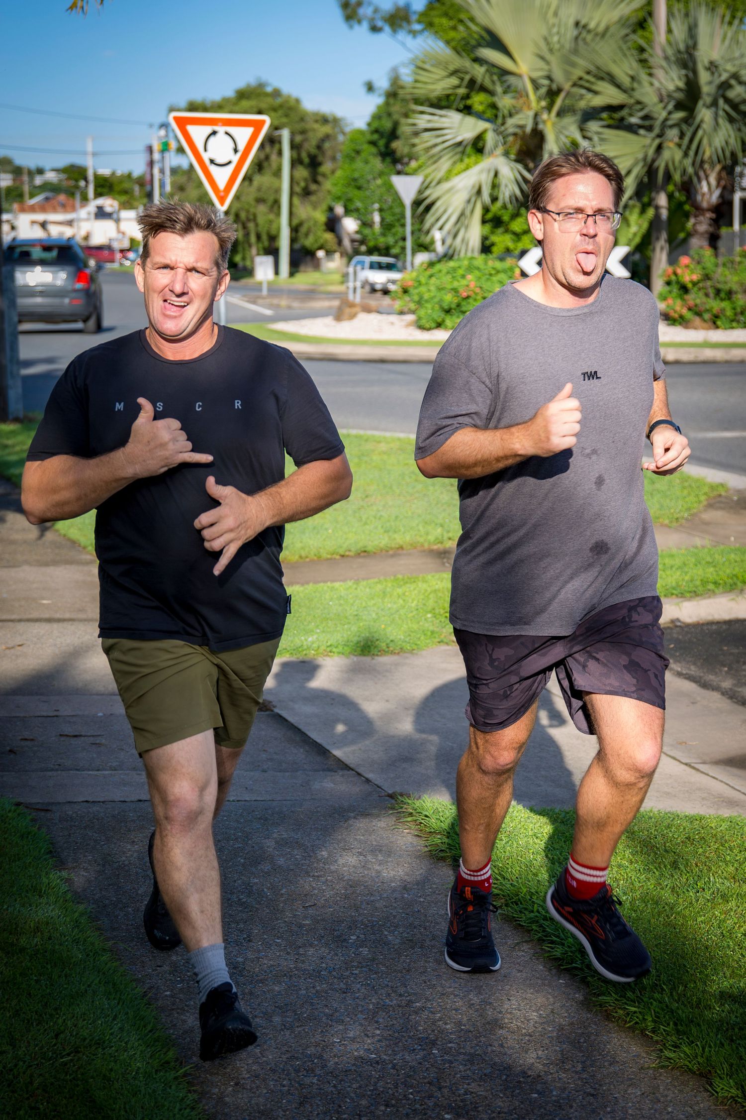 Two gym members on rower at CQ Fitness Co during high-energy workout