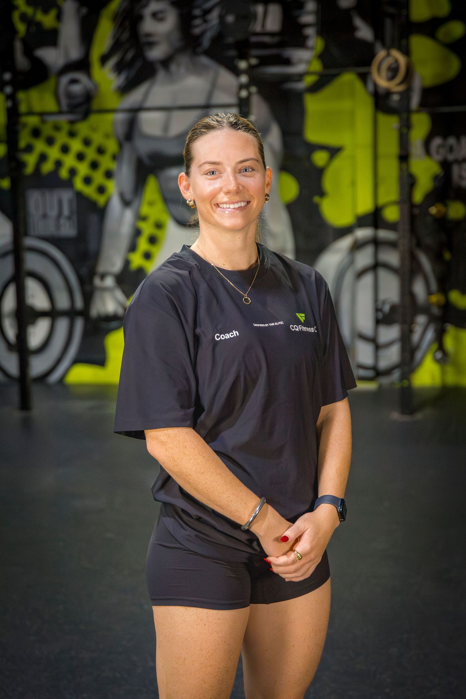 Gym coach headshots in front of gym mural at Rockhampton CrossFit location