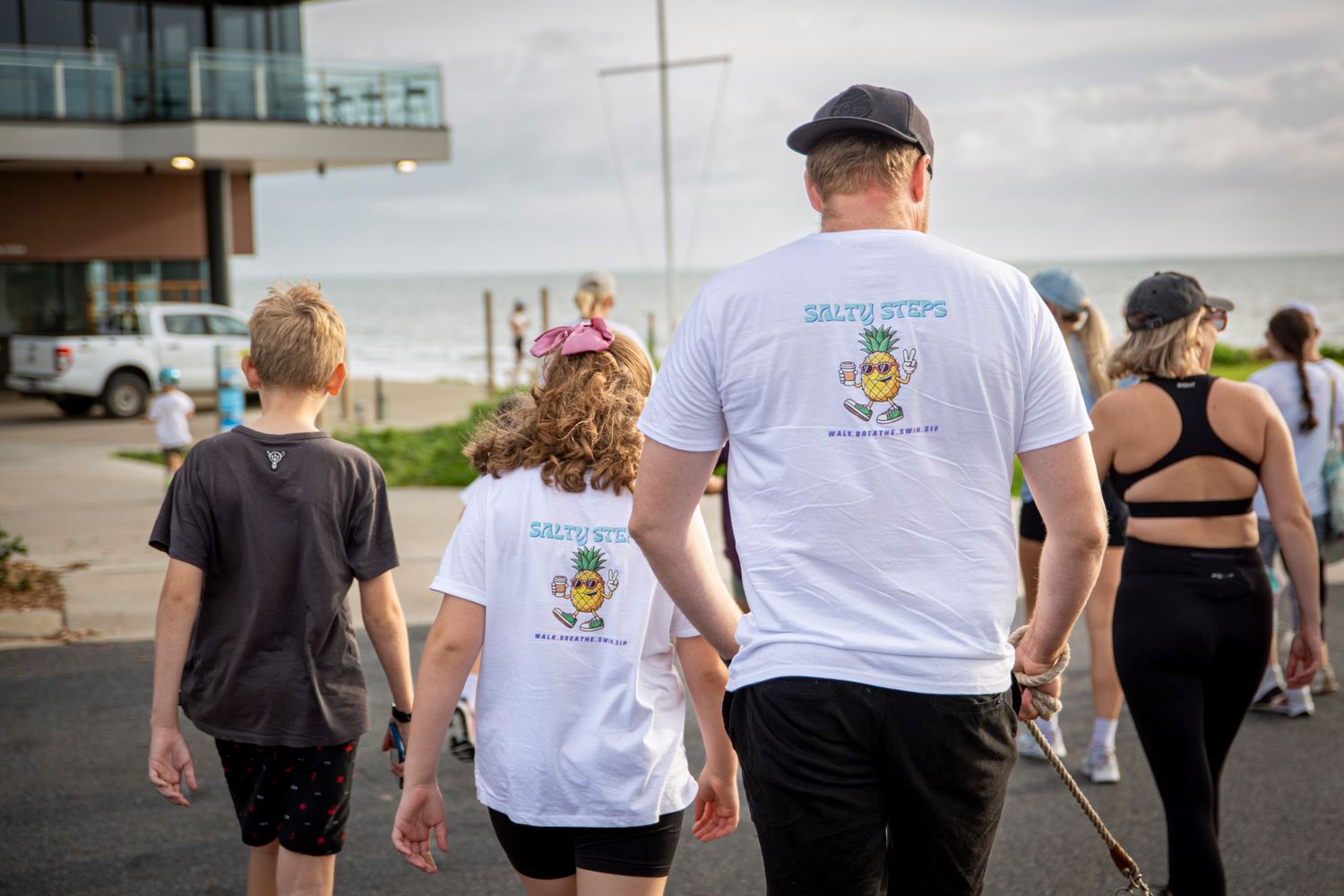 Crowd walking along coastal boardwalk at Salty Steps yeppoon