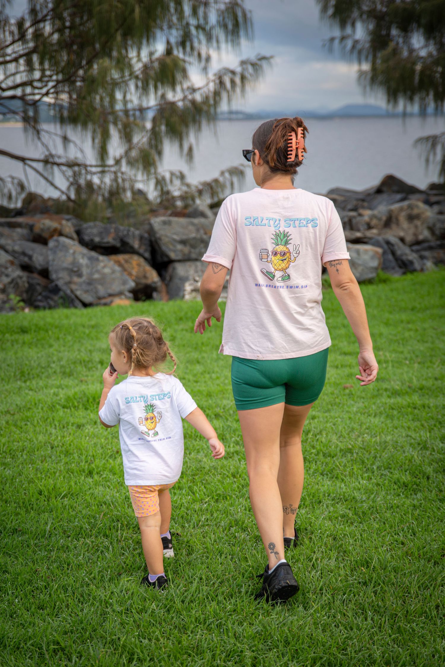 Group walking along scenic coastal path in yeppoon at community event