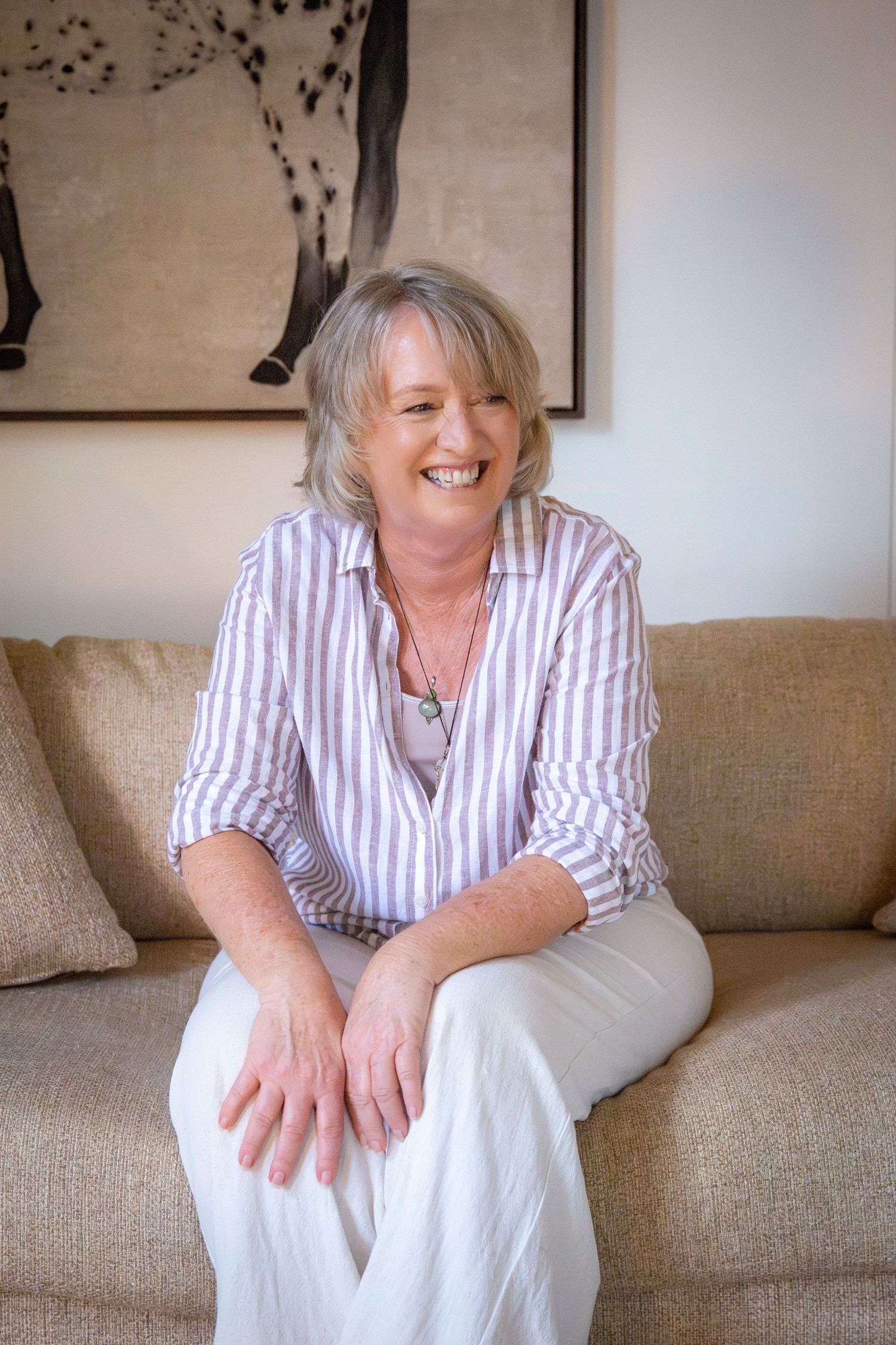 Natural light branding portrait of Yeppoon businesswoman seated on a couch
