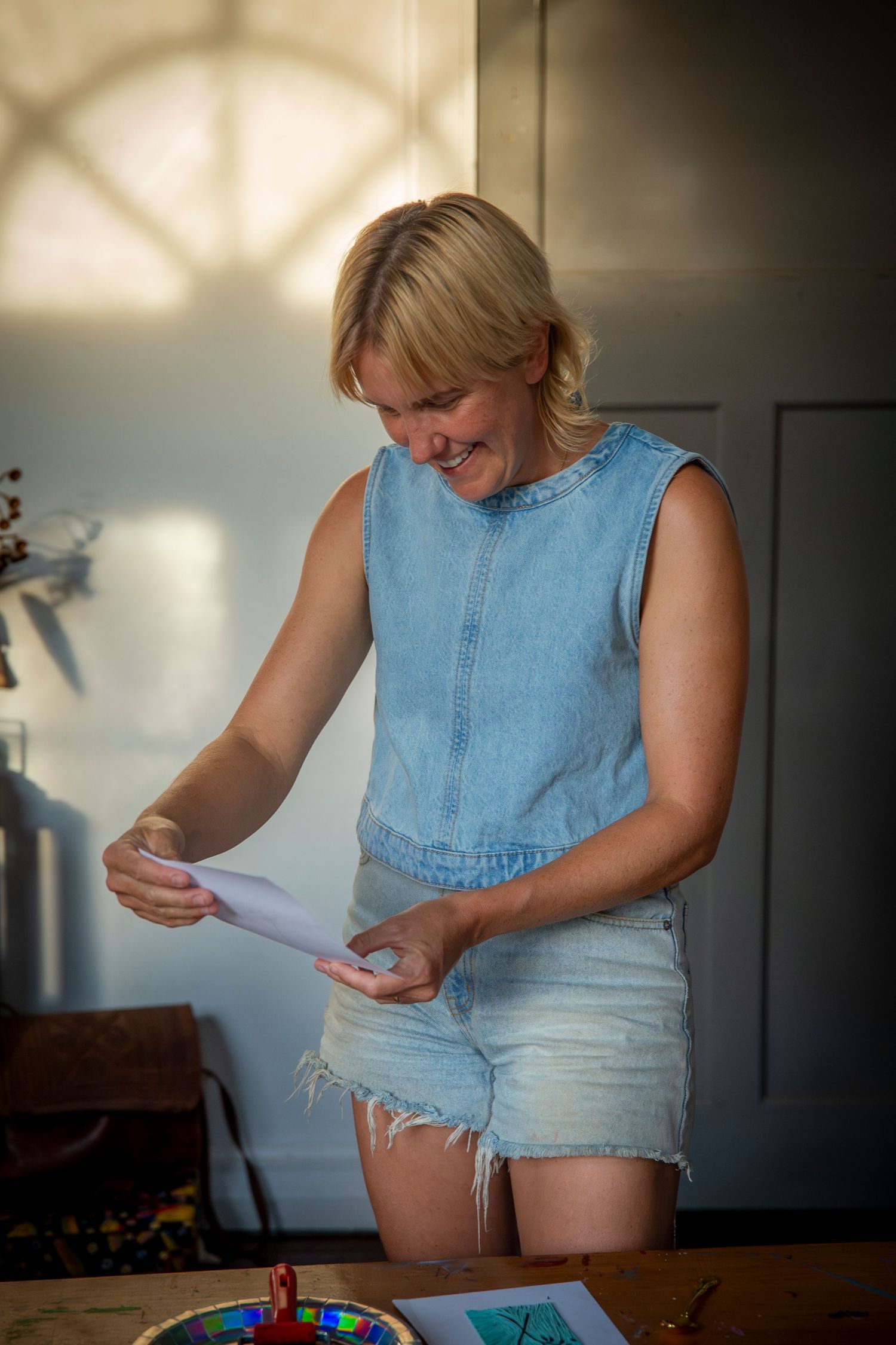 Woman admiring her art work at event in Rockhampton