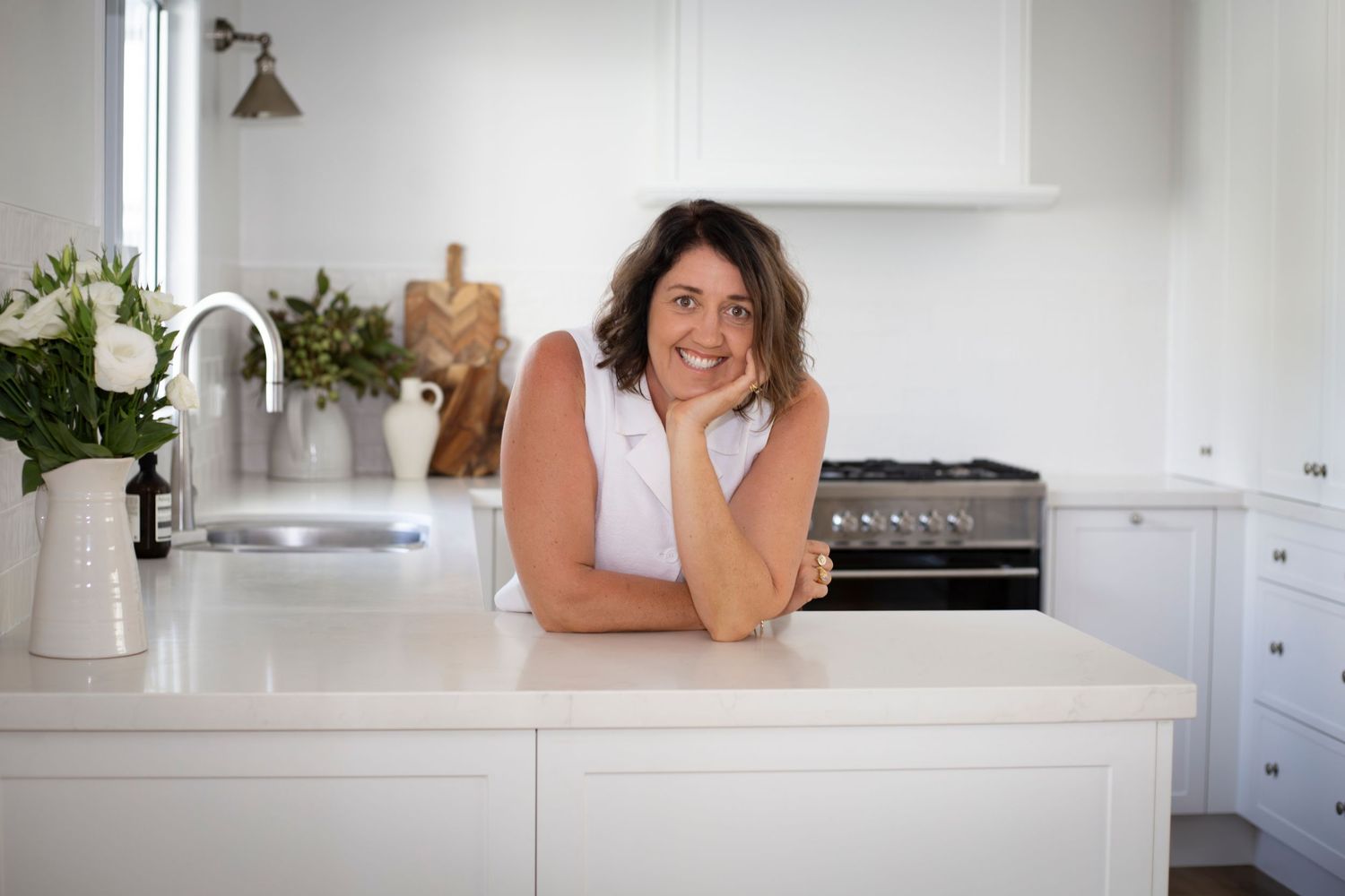 Personal branding photo of woman in modern white kitchen – Rockhampton minimal branding photographer