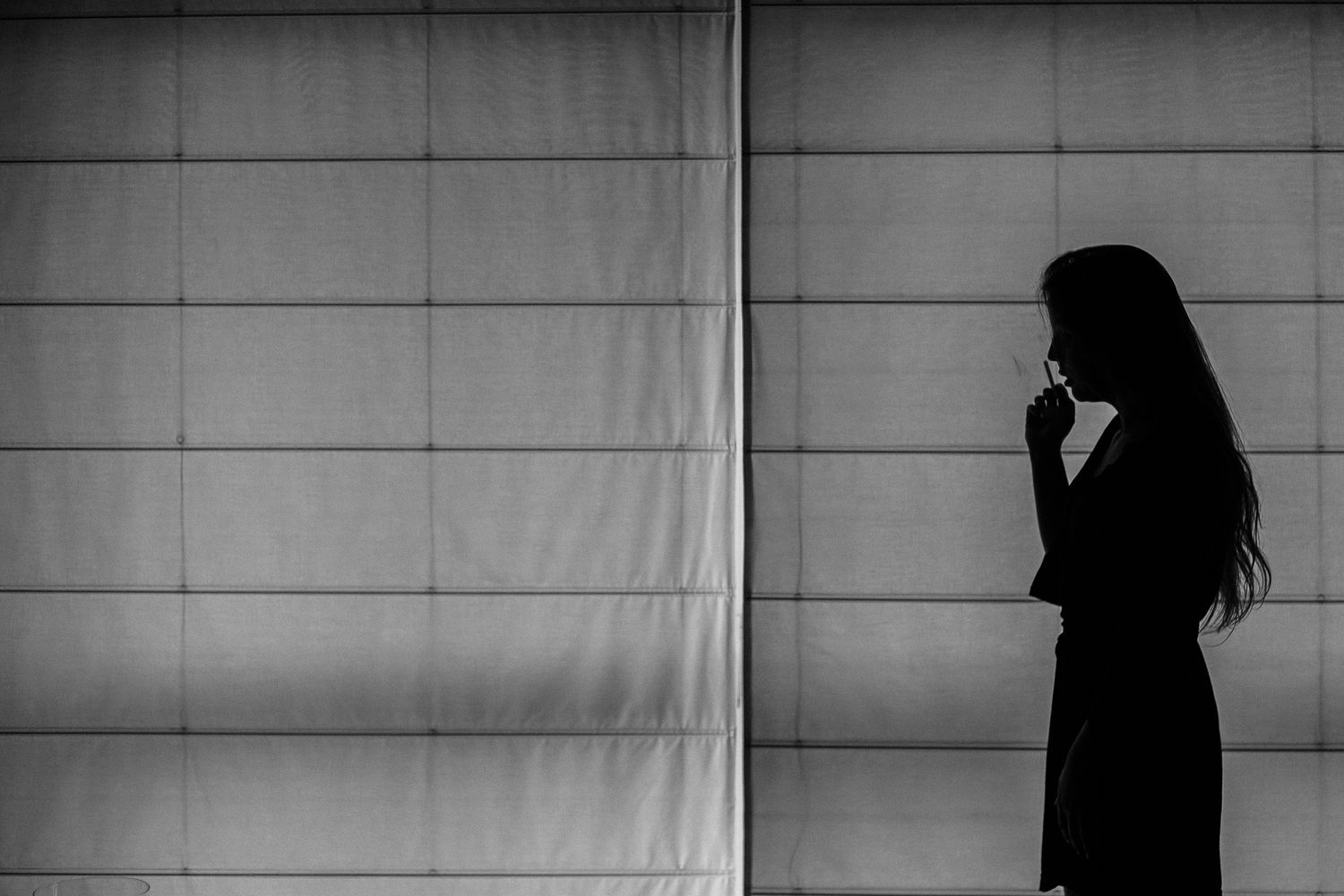 A black and white photo sequence shows a silhouette moving across a light background in six progressive frames.