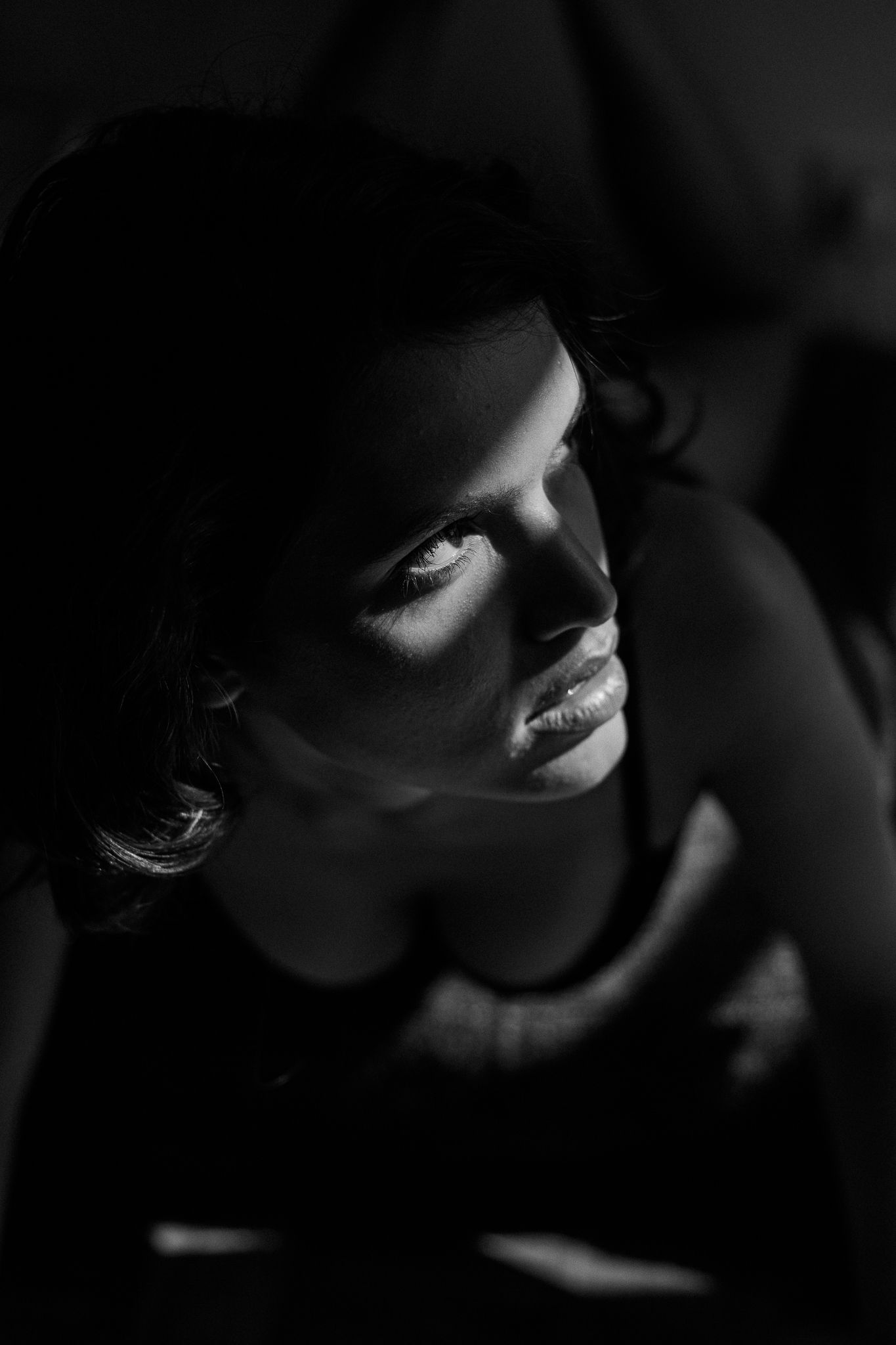 Dramatic black and white portrait series showing silhouetted facial features in moody lighting.