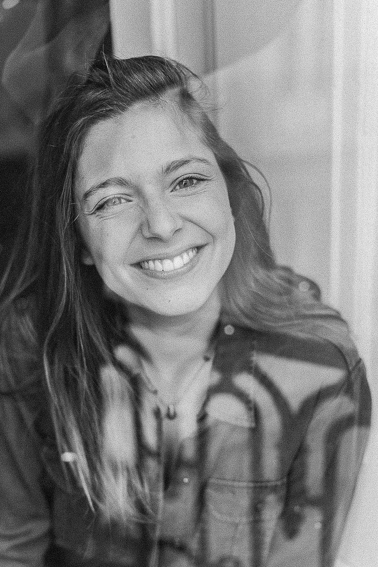 Black and white portrait series showing joyful expressions and genuine laughter in casual plaid attire.
