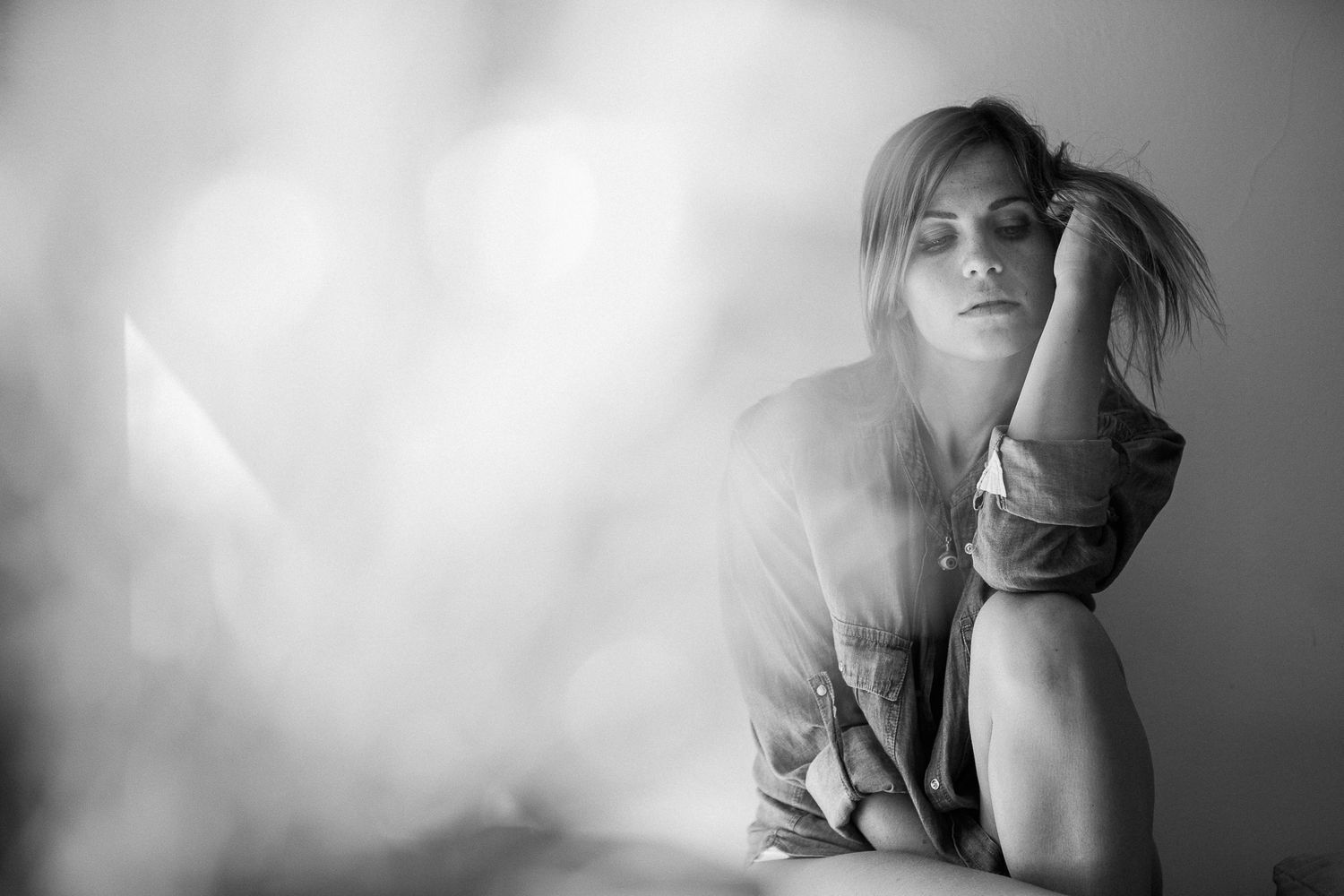 Black and white artistic portrait series showing moody and atmospheric poses with dramatic lighting and shadows.