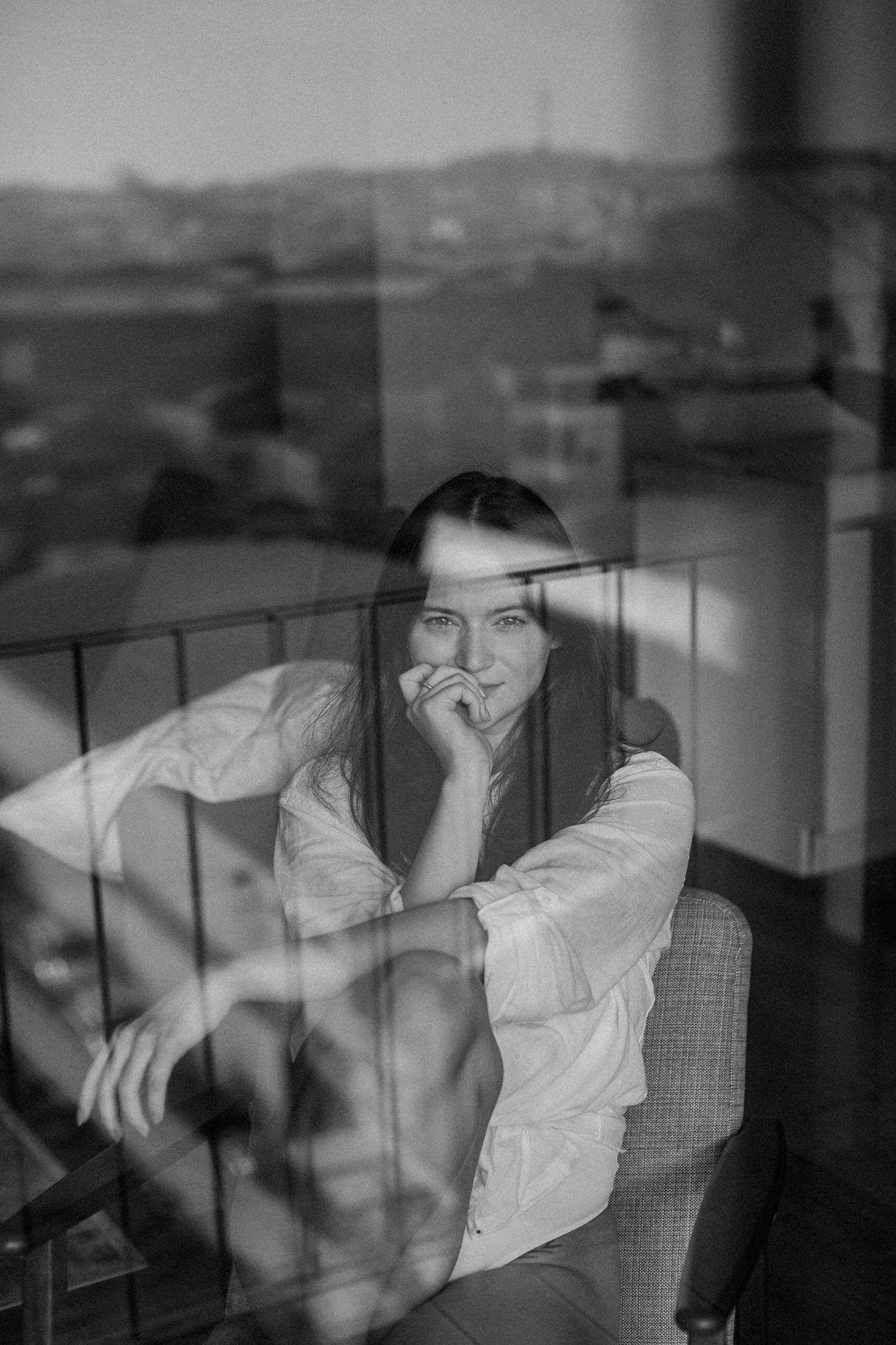 Dreamy black and white window portraits with reflections and natural lighting.