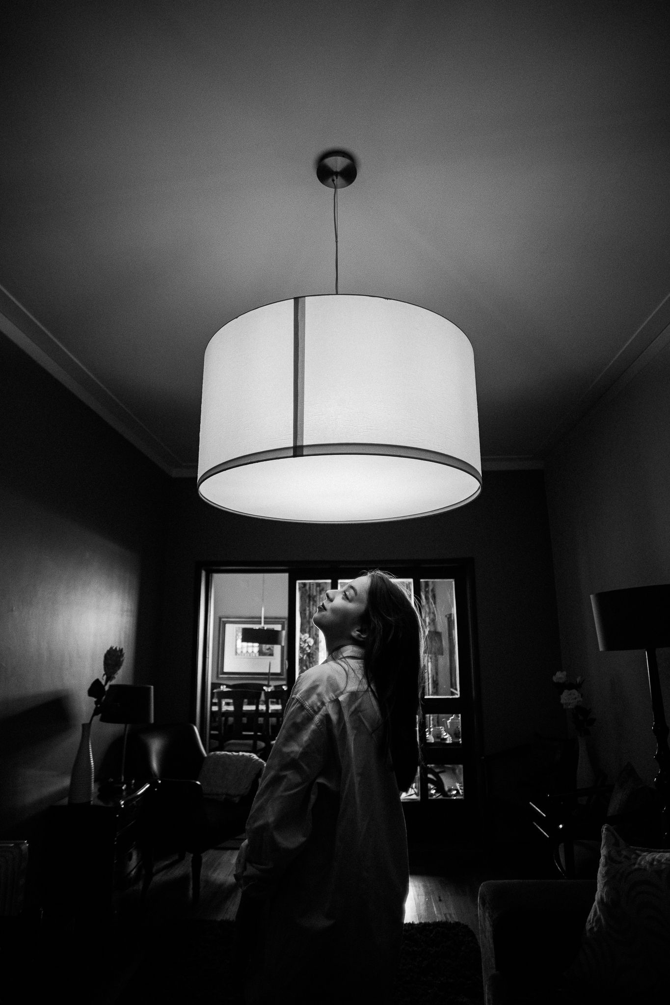 Interior room photos with dramatic drum pendant lighting creating moody shadows.