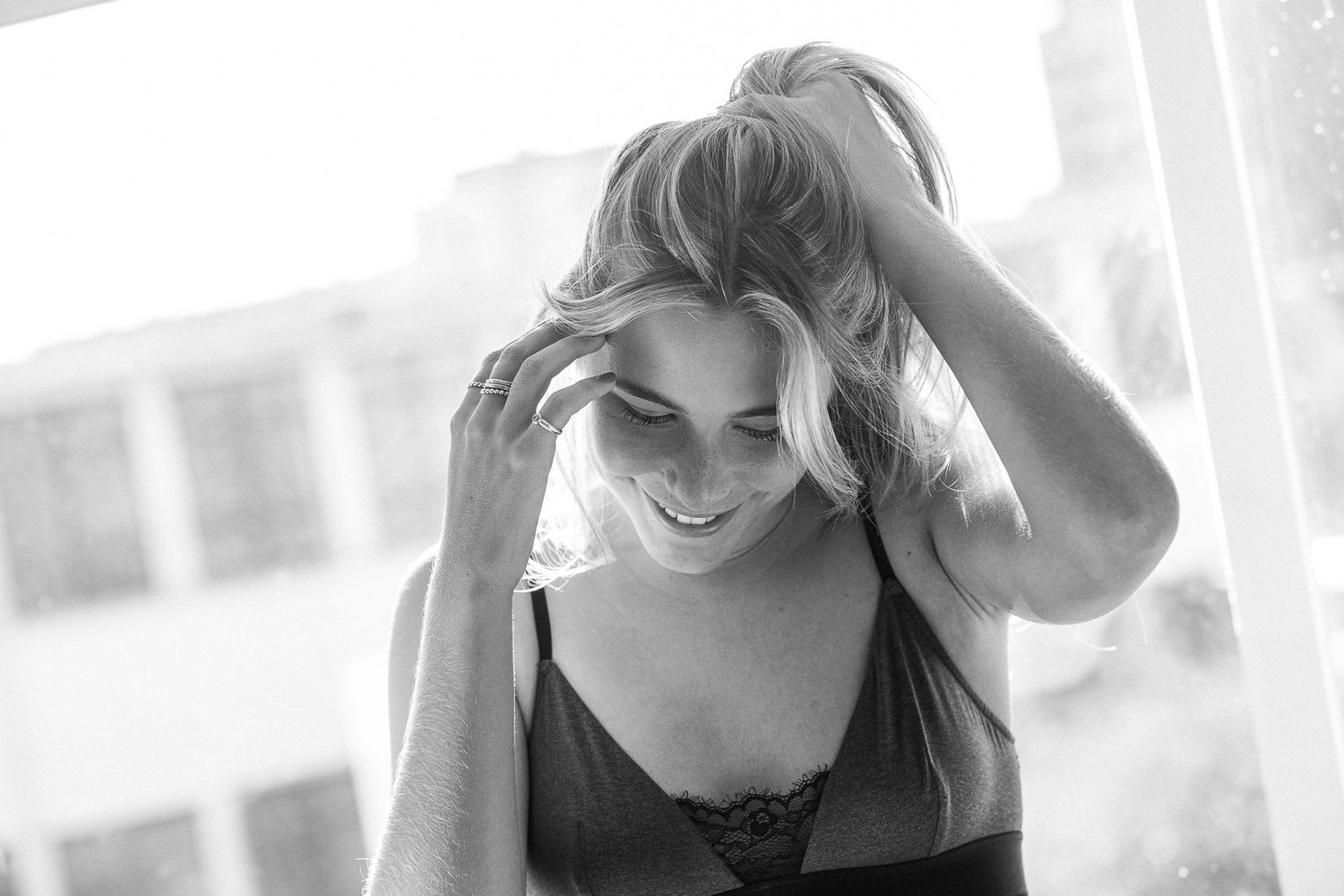 A black and white photo series shows a woman in different poses and expressions against a light background.