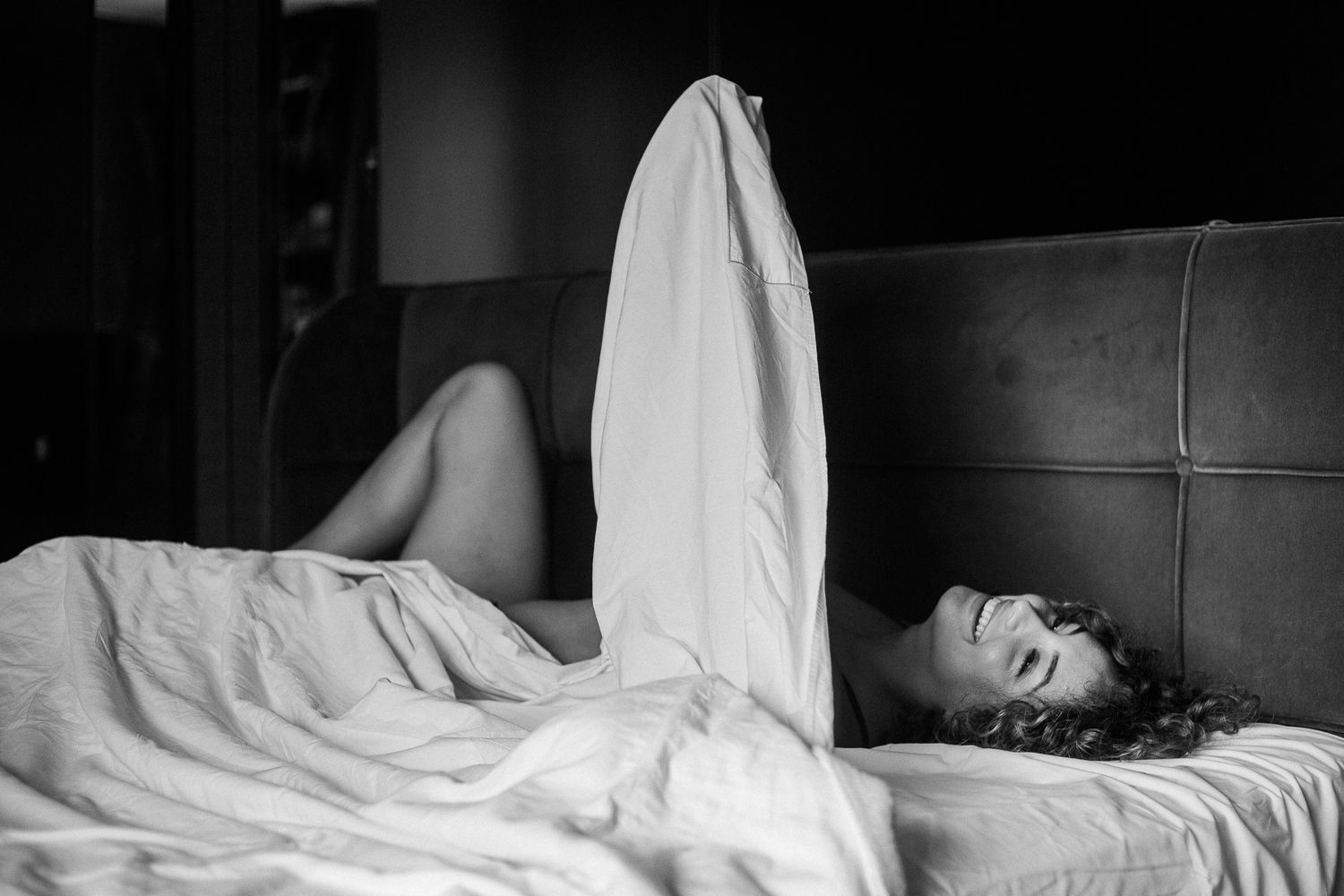 Black and white photo sequence showing someone tossing and turning restlessly in bed under white sheets.