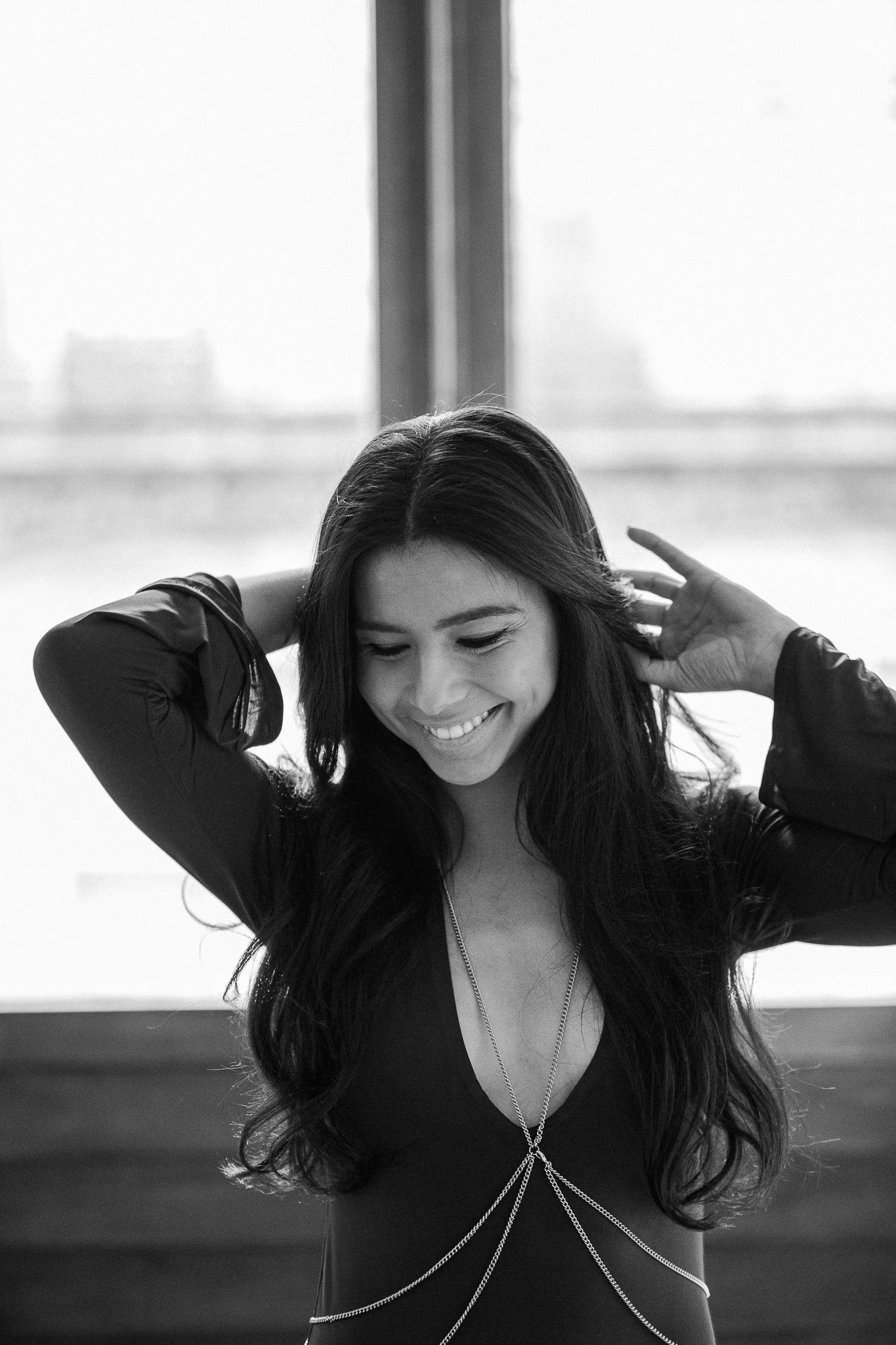 A black and white photo sequence shows someone with long dark hair playfully running their hands through their hair.