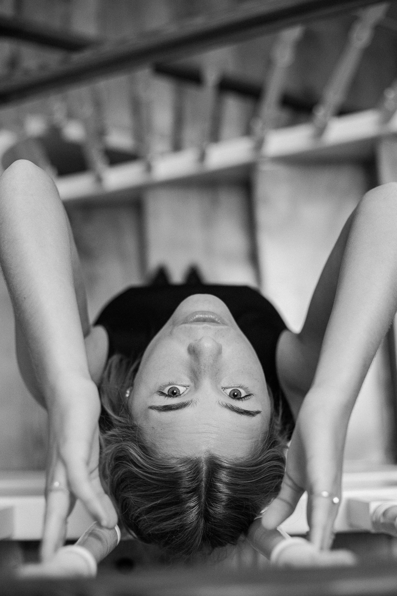 A black and white artistic photo series showing an upside down view of someone's head and shoulders.