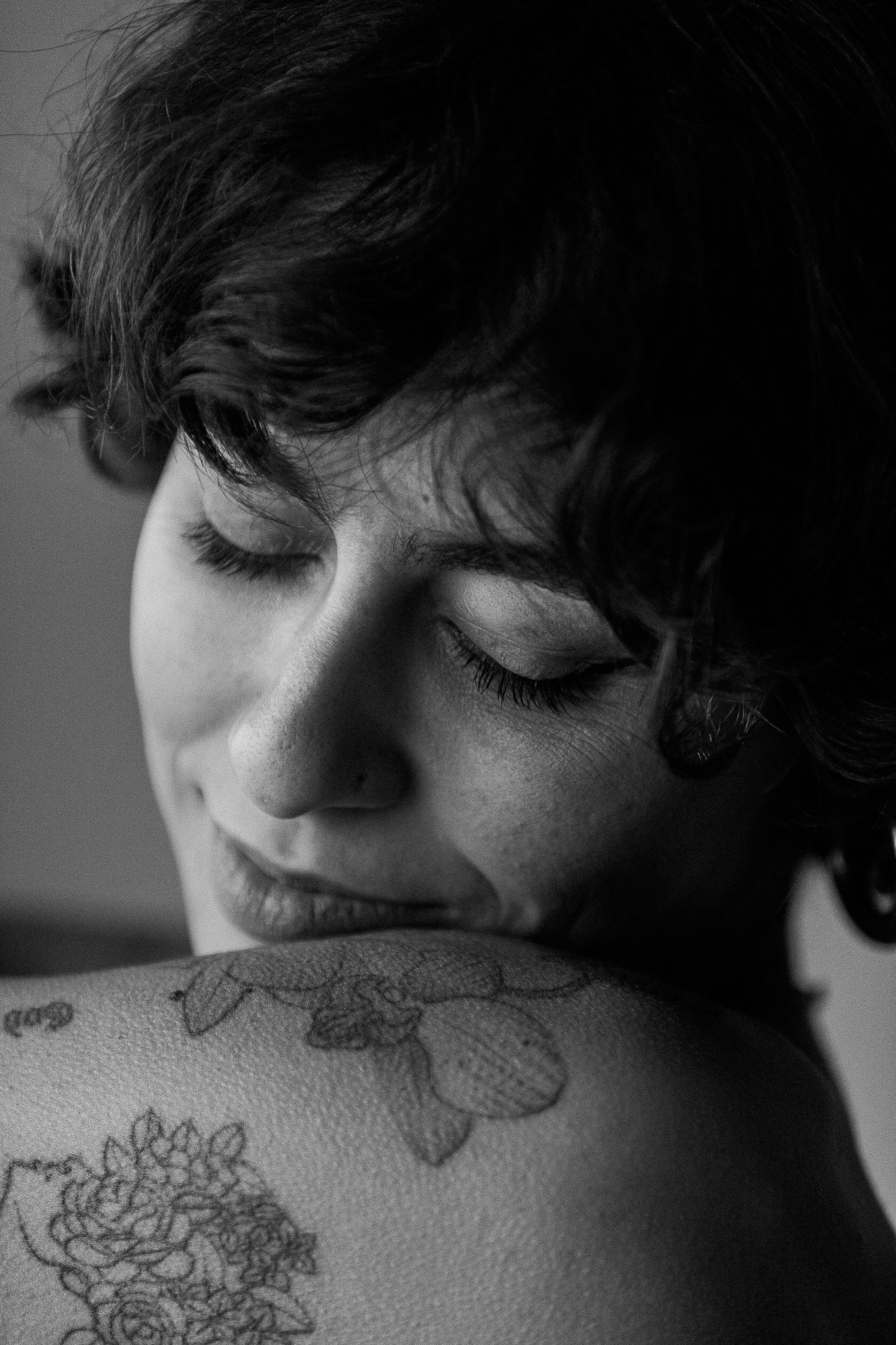 Close-up black and white shots revealing delicate floral tattoo details.