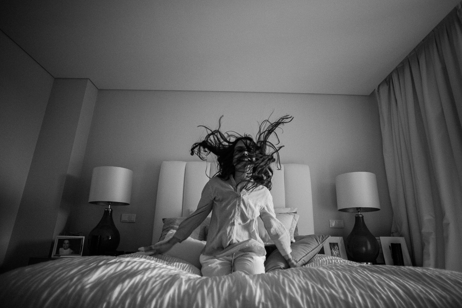 Minimalist bedroom photo series with dramatic lighting and shadows.