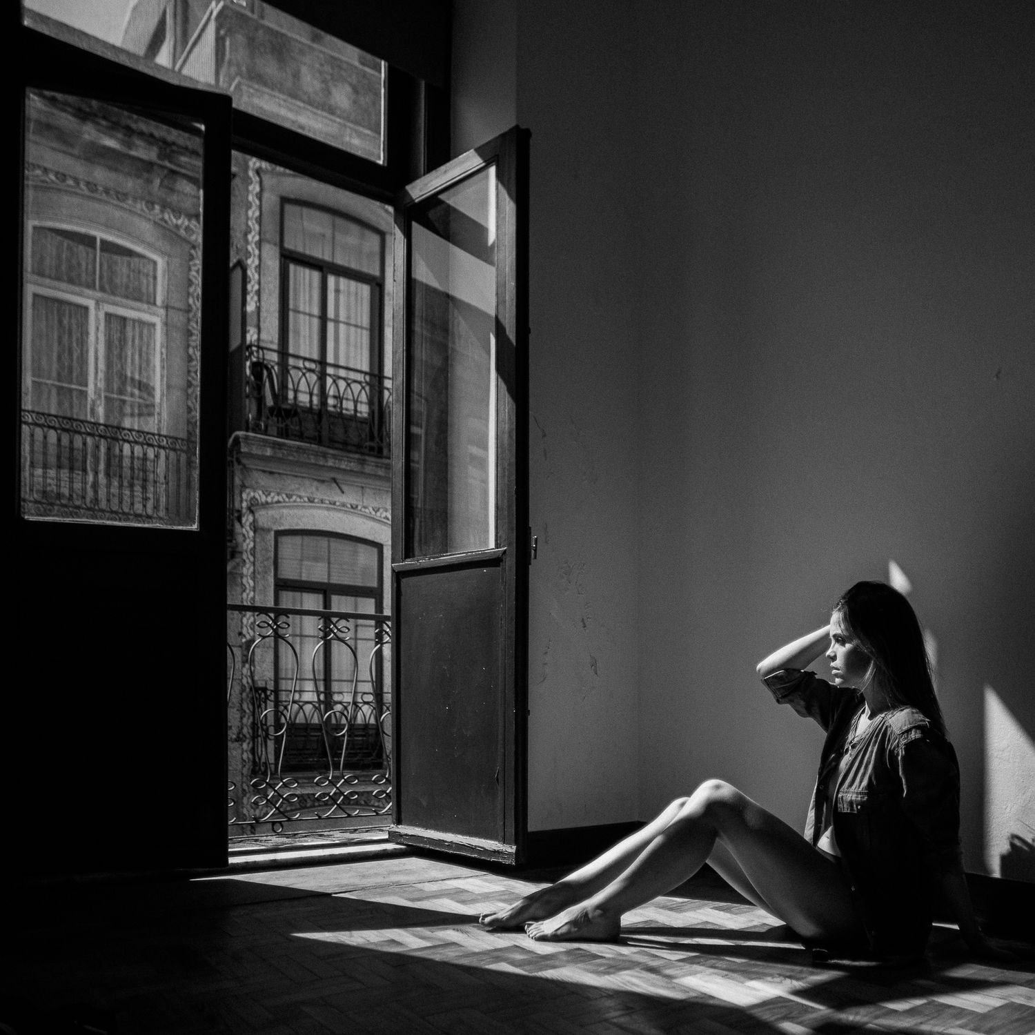Dramatic black and white photo series showing silhouettes of figures in sunlit rooms with ornate balconies visible outside.