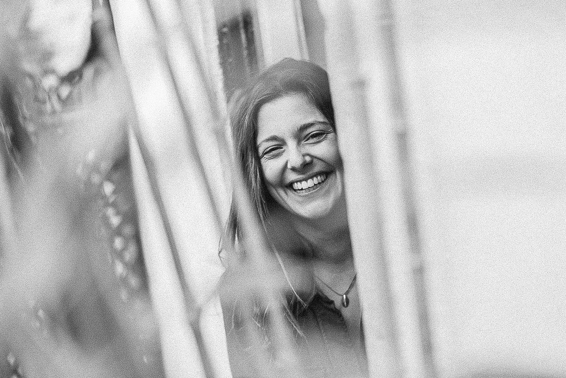A series of black and white candid wedding photos showing joyful moments and laughter.