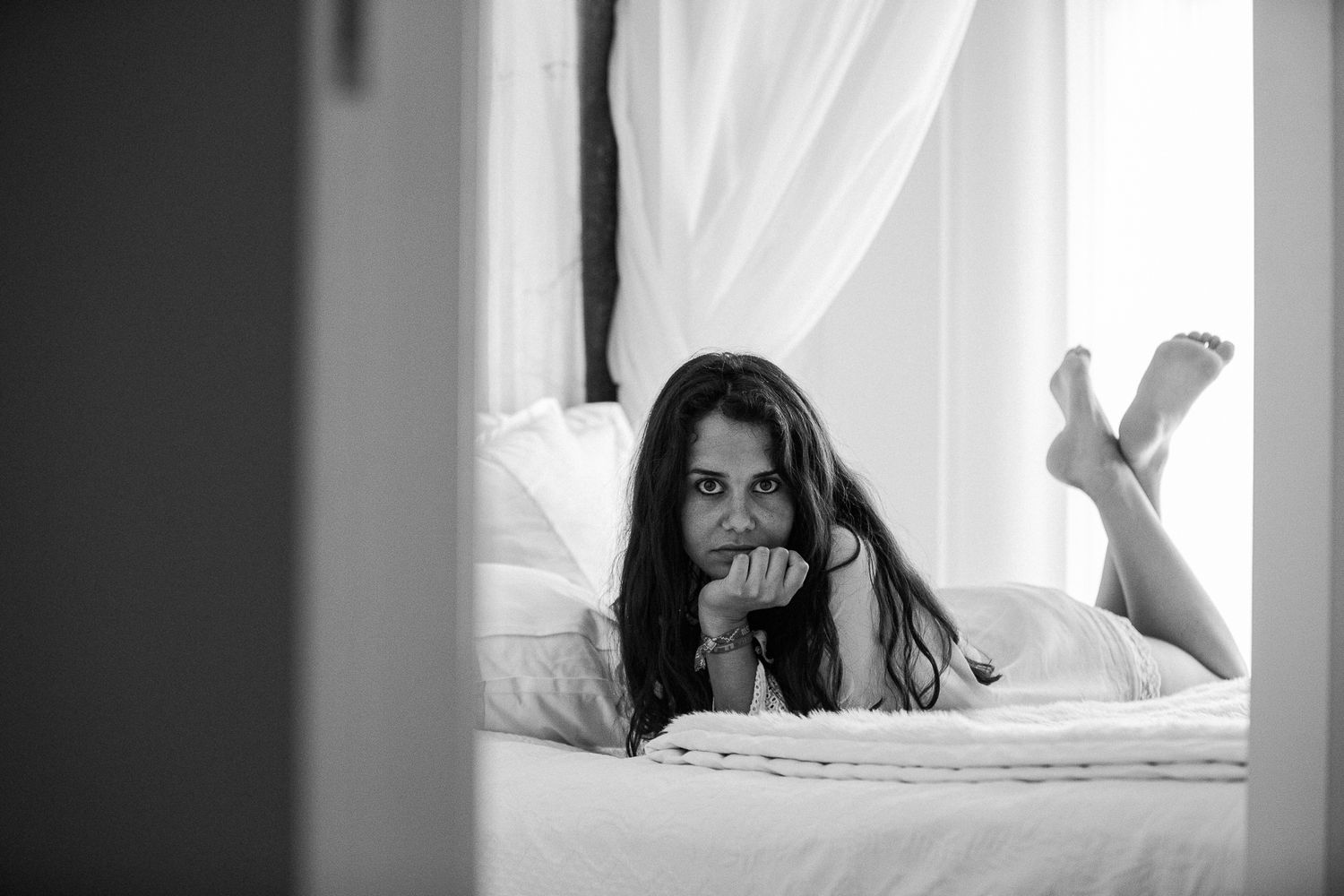 Series of artistic shots showing movement behind sheer white curtains.