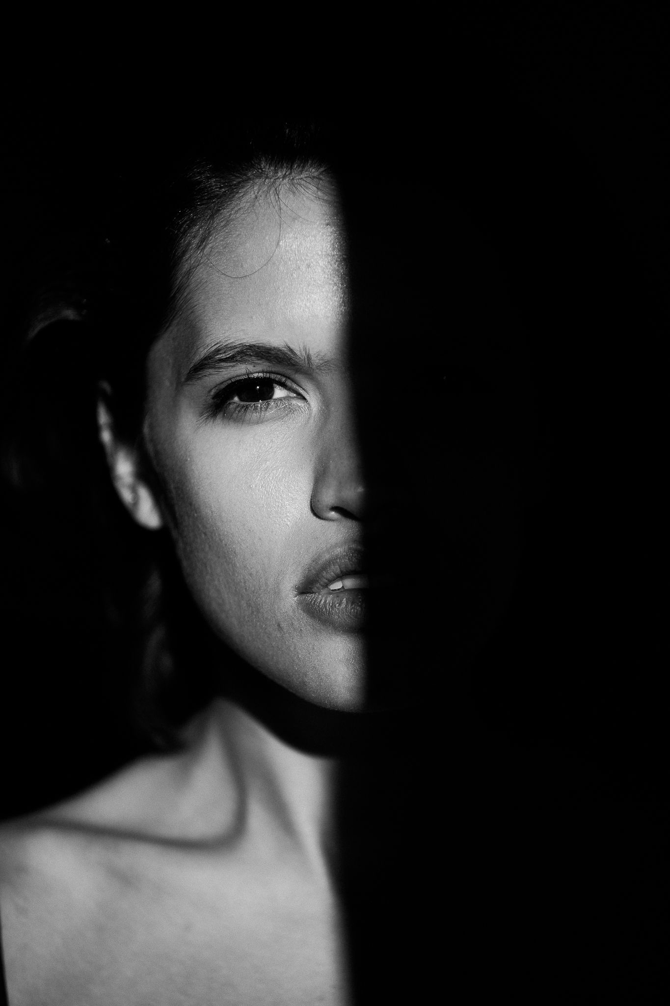 A dramatic black and white portrait series showing different angles of a face partially concealed in shadow.