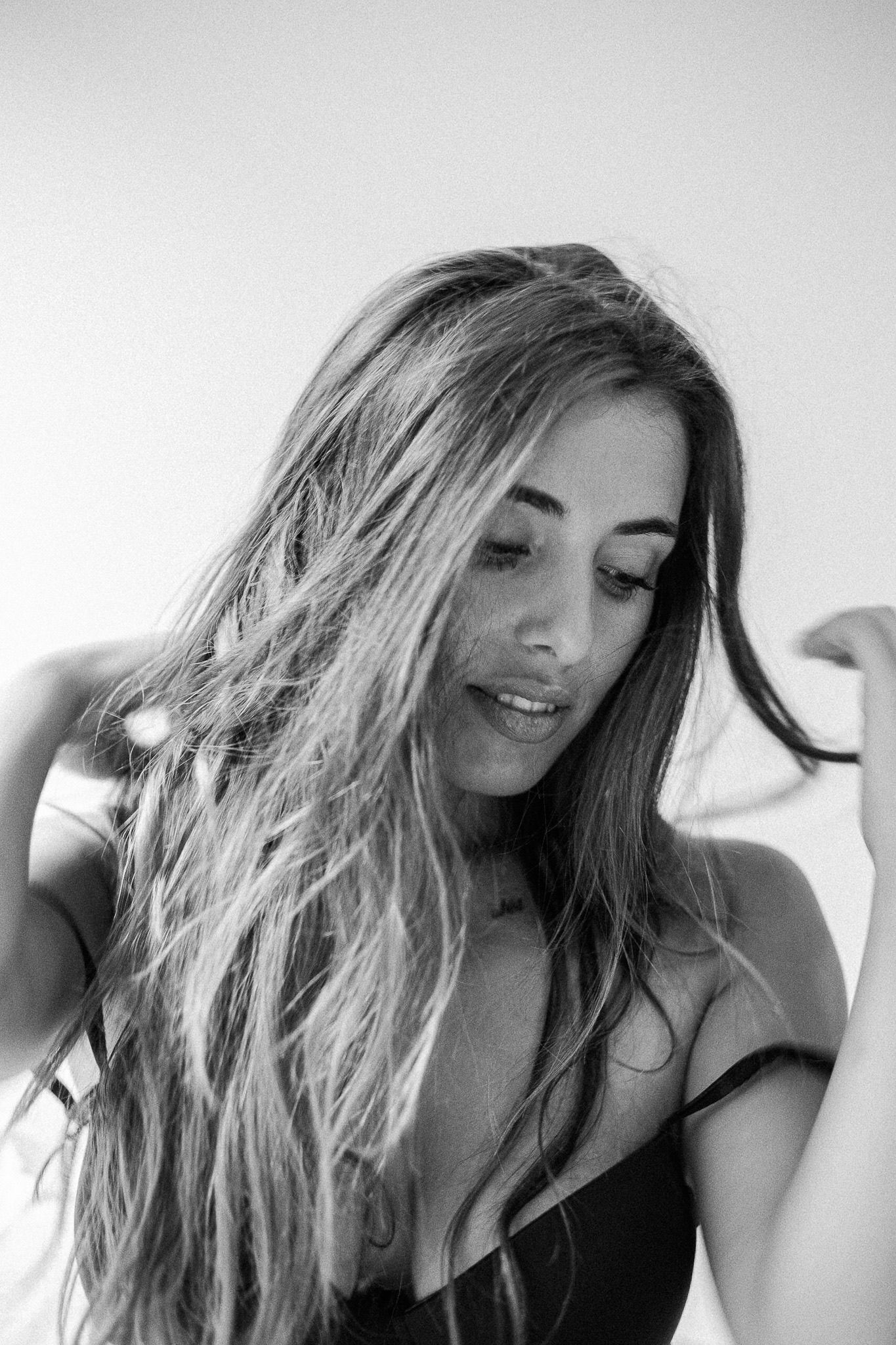 Monochrome photo sequence capturing flowing hair movement and expressions.