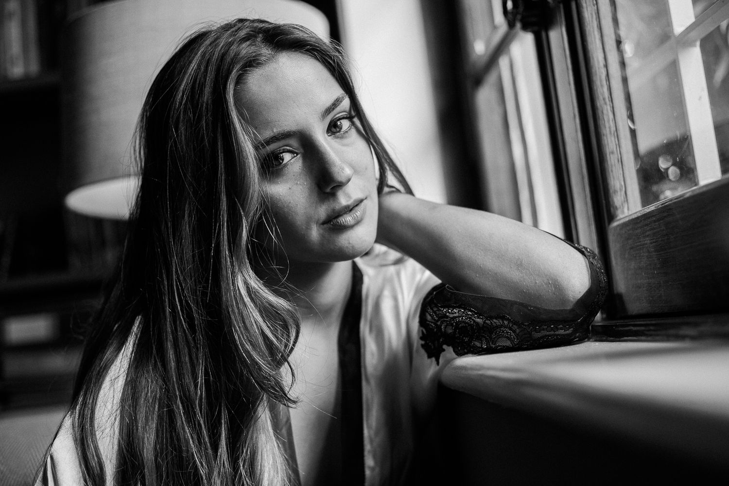 Black and white portrait series showing different expressive poses and candid moments in natural lighting.