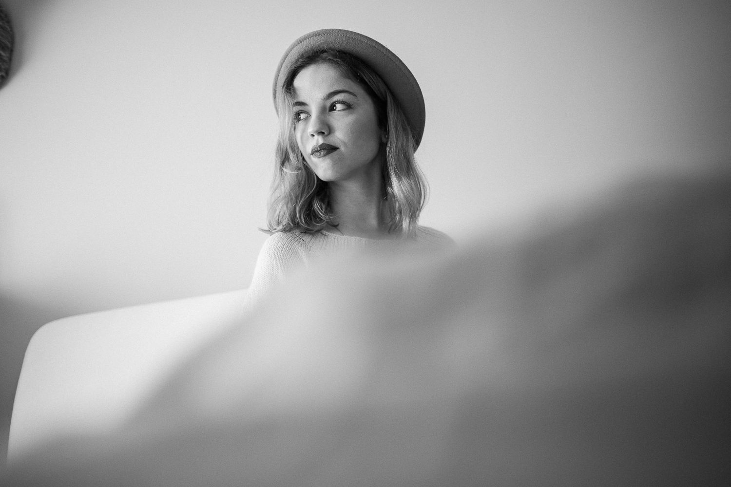 A black and white portrait series showing dramatic close-up shots with moody lighting and soft focus effects.