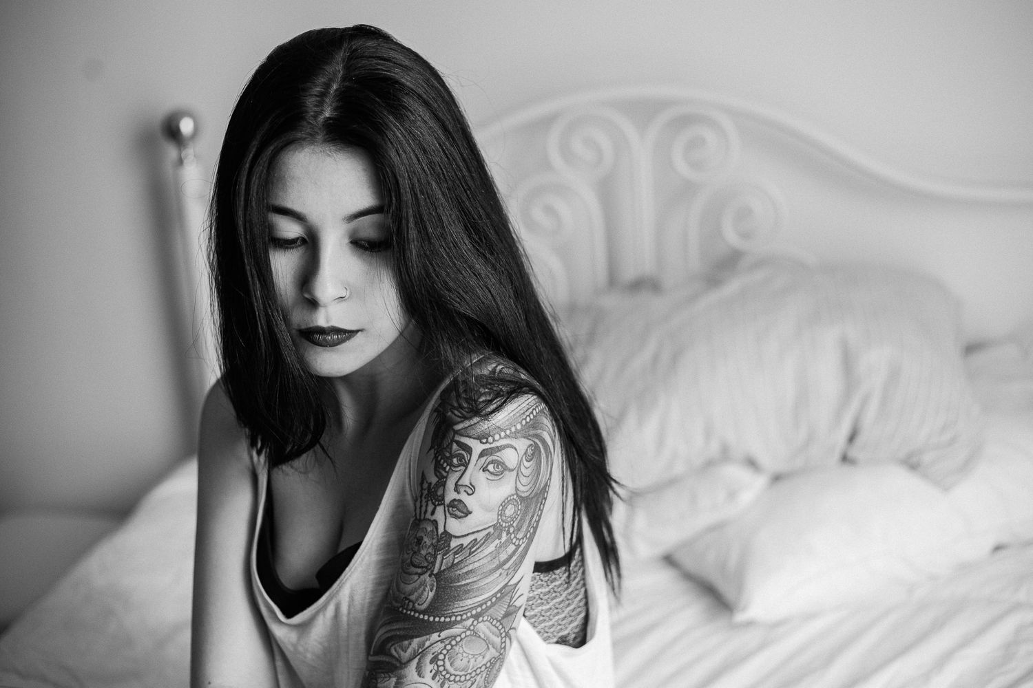 Black and white boudoir photography series showing intimate bedroom scenes with romantic lighting and elegant decor.