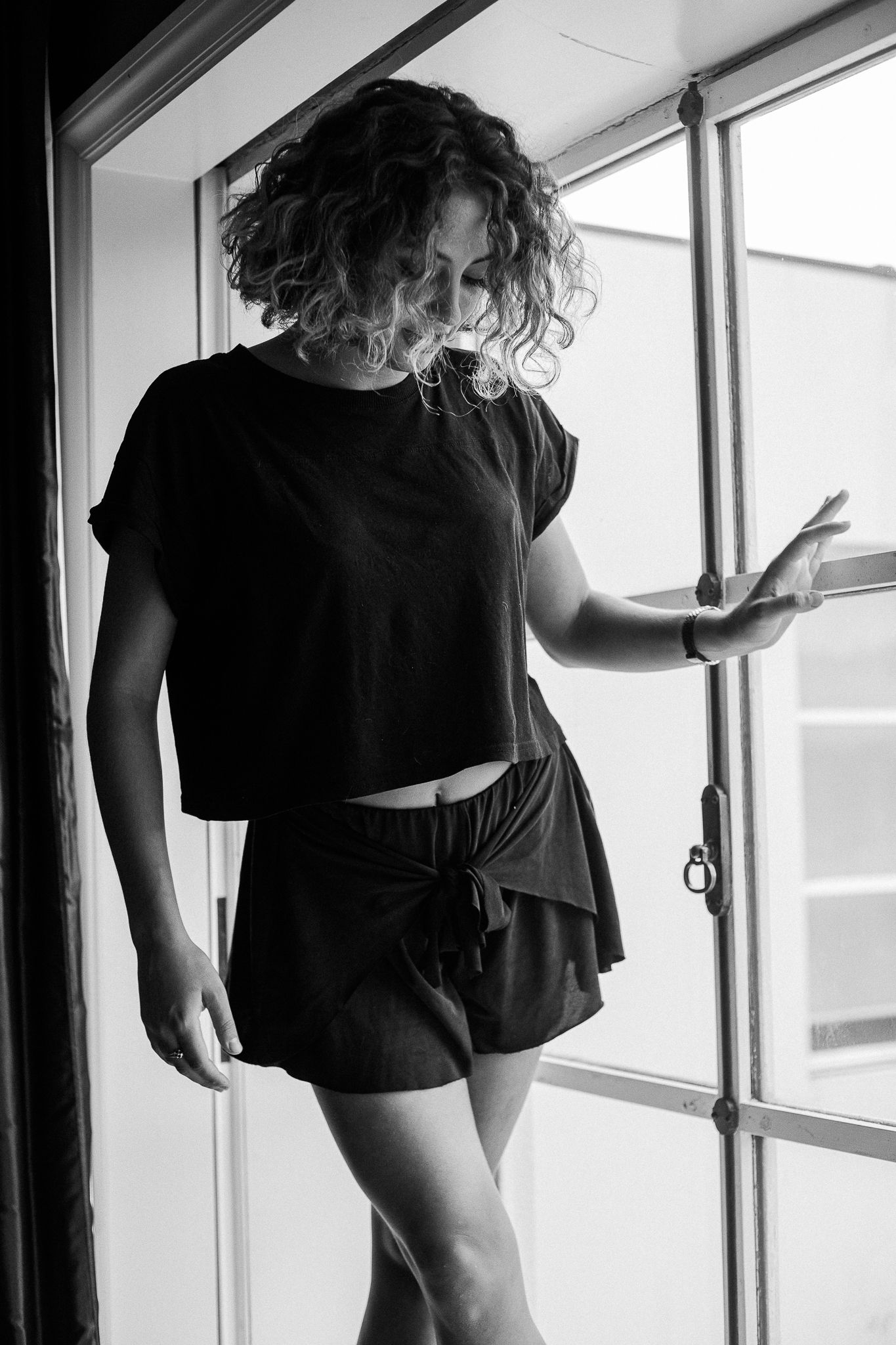 Black and white artistic photo sequence showing a dancer in flowing motion against a bright window backdrop.